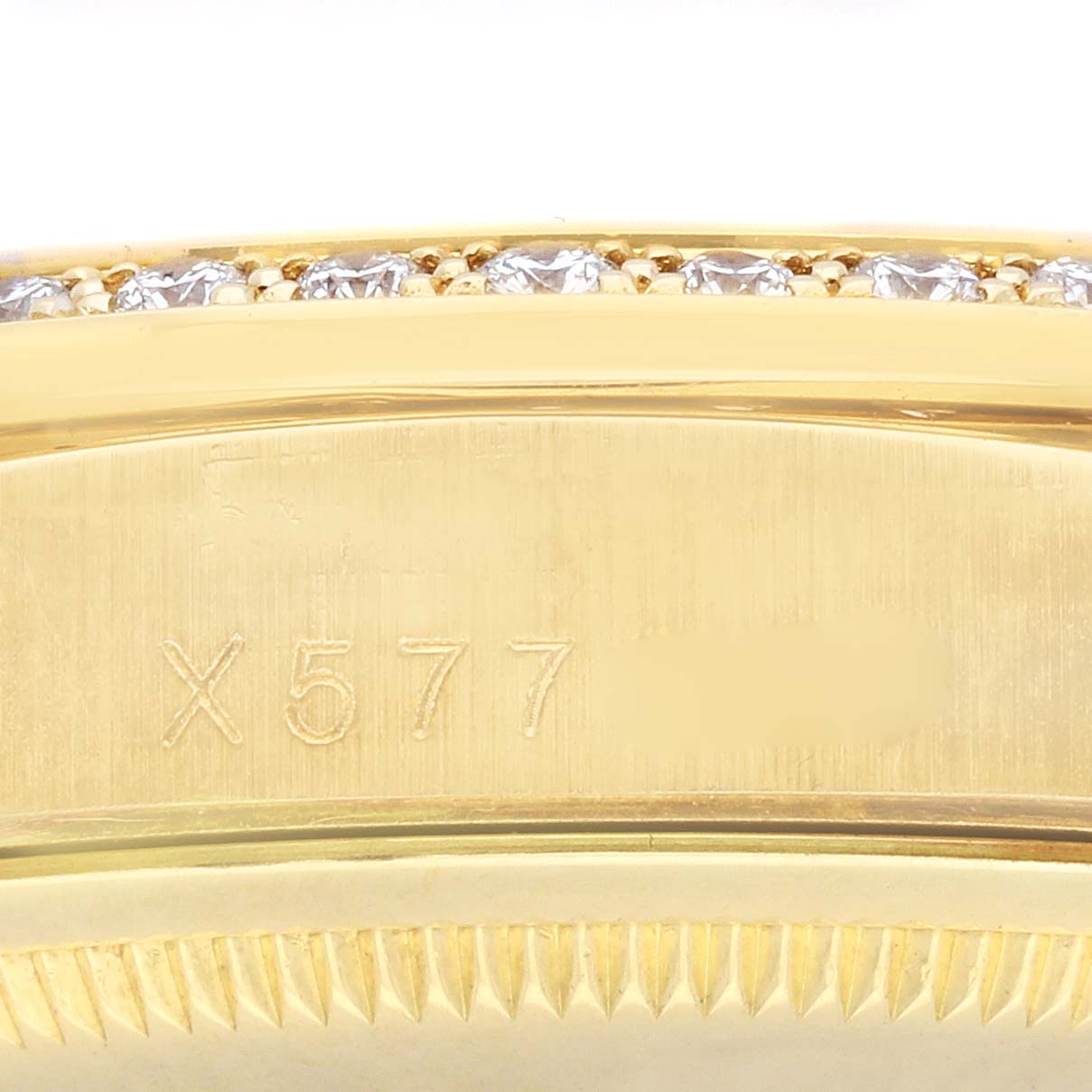 The image shows a close-up of the engraved side and diamond-set bezel of the Rolex President 18388 Men's Yellow Gold Champagne Dial 18388 Men's Yellow Gold Champagne Dial model.