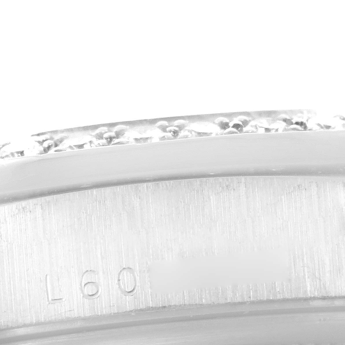 This close-up image shows the side edge, including engravings, of a Rolex President 18346 Men's Platinum Silver Dial 18346 Men's Platinum Silver Dial model watch.