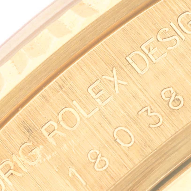 The image shows a close-up of the gold bezel engraving on a Rolex President 18038 Men
s Yellow Gold Champagne Dial 18038 Men
s Yellow Gold Champagne Dial model.