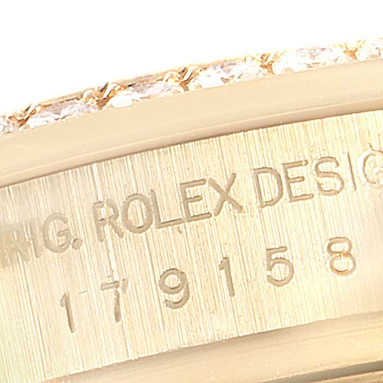 The image shows a close-up of the case side engraving on a Rolex President 179158 Women's Yellow Gold Champagne Dial 179158 Women's Yellow Gold Champagne Dial model watch.