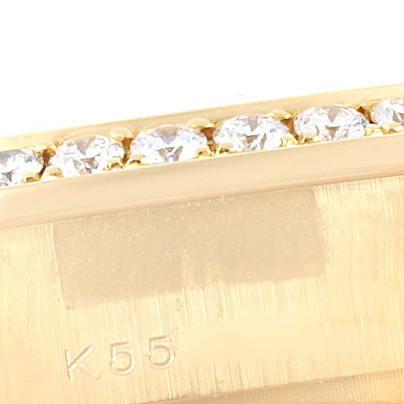 This close-up image shows a partial view of the diamond bezel and gold casing of a Rolex President 179158 Women's Yellow Gold Champagne Dial 179158 Women's Yellow Gold Champagne Dial model watch.
