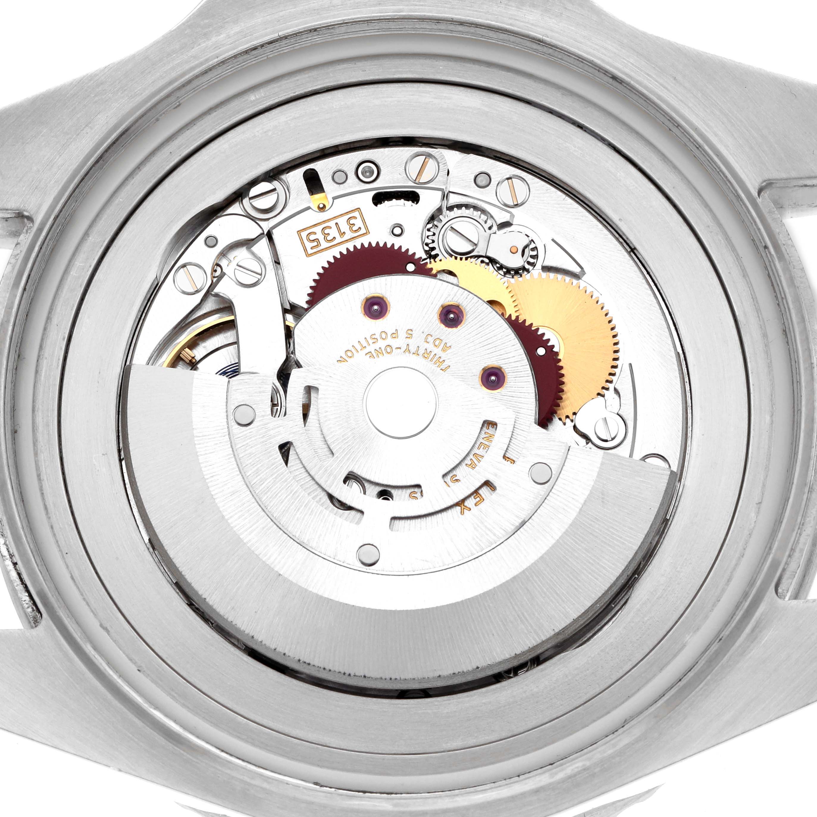 The image shows a close-up of the movement inside a Rolex Sea-Dweller 116660 Men
s Stainless Steel Black Dial, displaying gears and mechanical components.