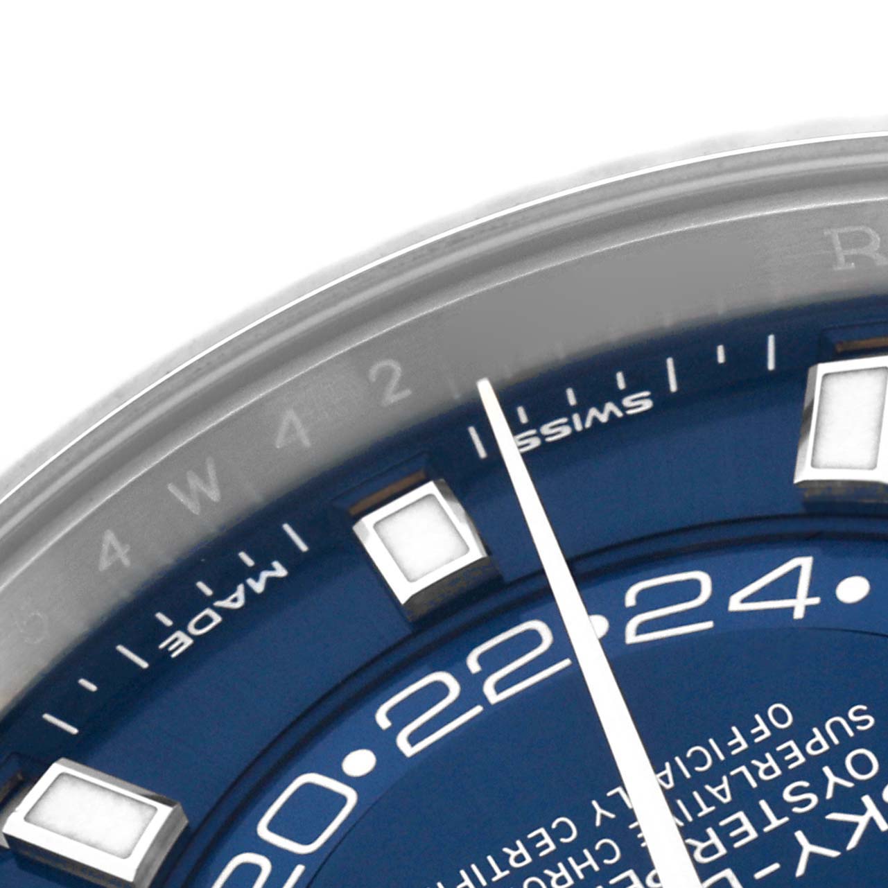 The image shows a close-up of the dial and bezel of a Rolex Sky-Dweller 326934 Men
s Stainless Steel Blue Dial, focusing on the hour markers and part of the 24-hour display.