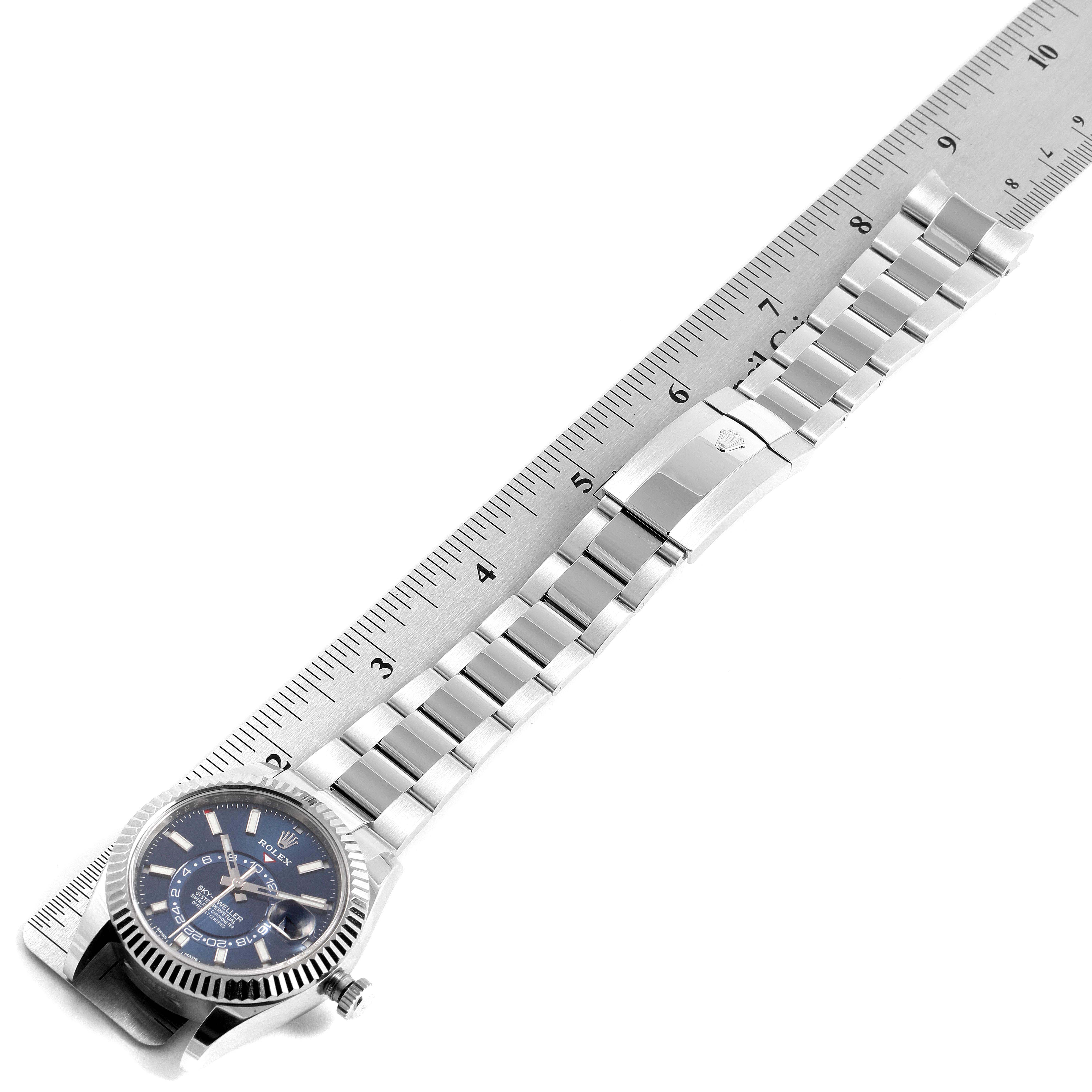 The image shows the face and bracelet of a Rolex Sky-Dweller 326934 Men's Stainless Steel Blue Dial 326934 Men's Stainless Steel Blue Dial watch, measured against a ruler from a top-down angle.