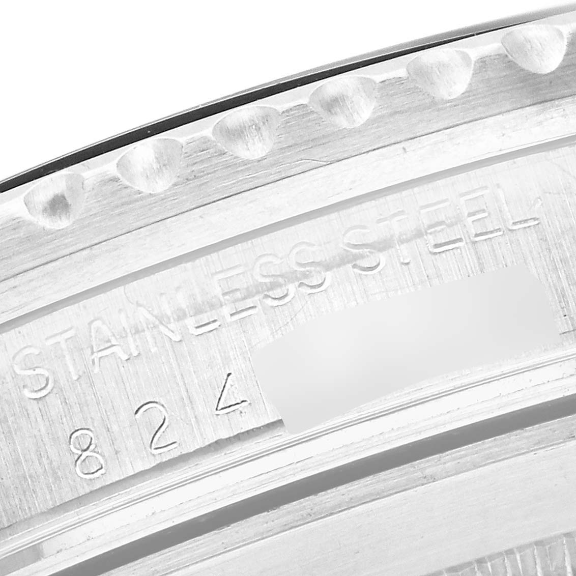 The image shows a close-up of the engraved side of the bezel on a Rolex Vintage Collection 16800 Men's Stainless Steel Black Dial 16800 Men's Stainless Steel Black Dial watch.