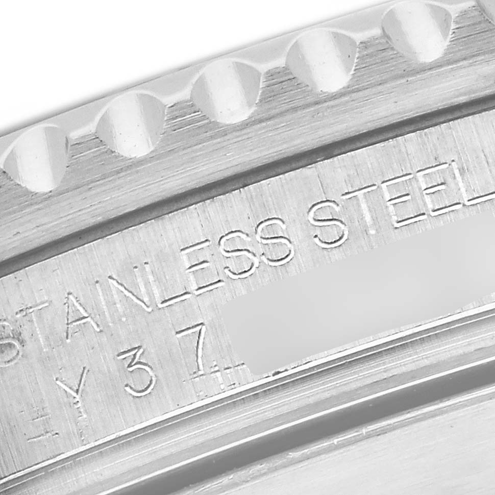 The image shows an angled close-up of the engraving on the Rolex Submariner 16610 Men
s Stainless Steel Black Dial 16610 Men
s Stainless Steel Black Dial
s stainless steel case, highlighting the text details.