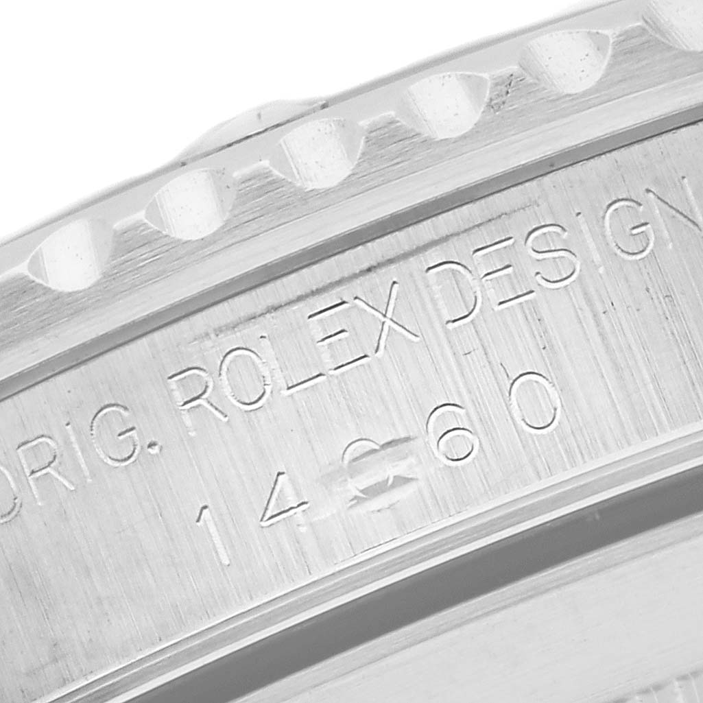 The image shows a close-up of the engraved side detailing on a Rolex Submariner 14060 Men
s Stainless Steel Black Dial 14060 Men
s Stainless Steel Black Dial watch.