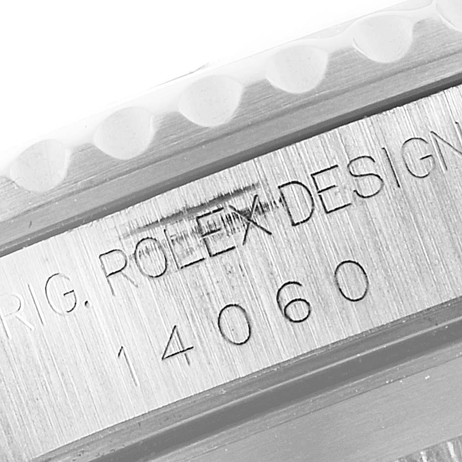 This image shows a close-up of the side view of a Rolex Submariner 14060 Men
s Stainless Steel Black Dial 14060 Men
s Stainless Steel Black Dial, highlighting the serial number and model details.