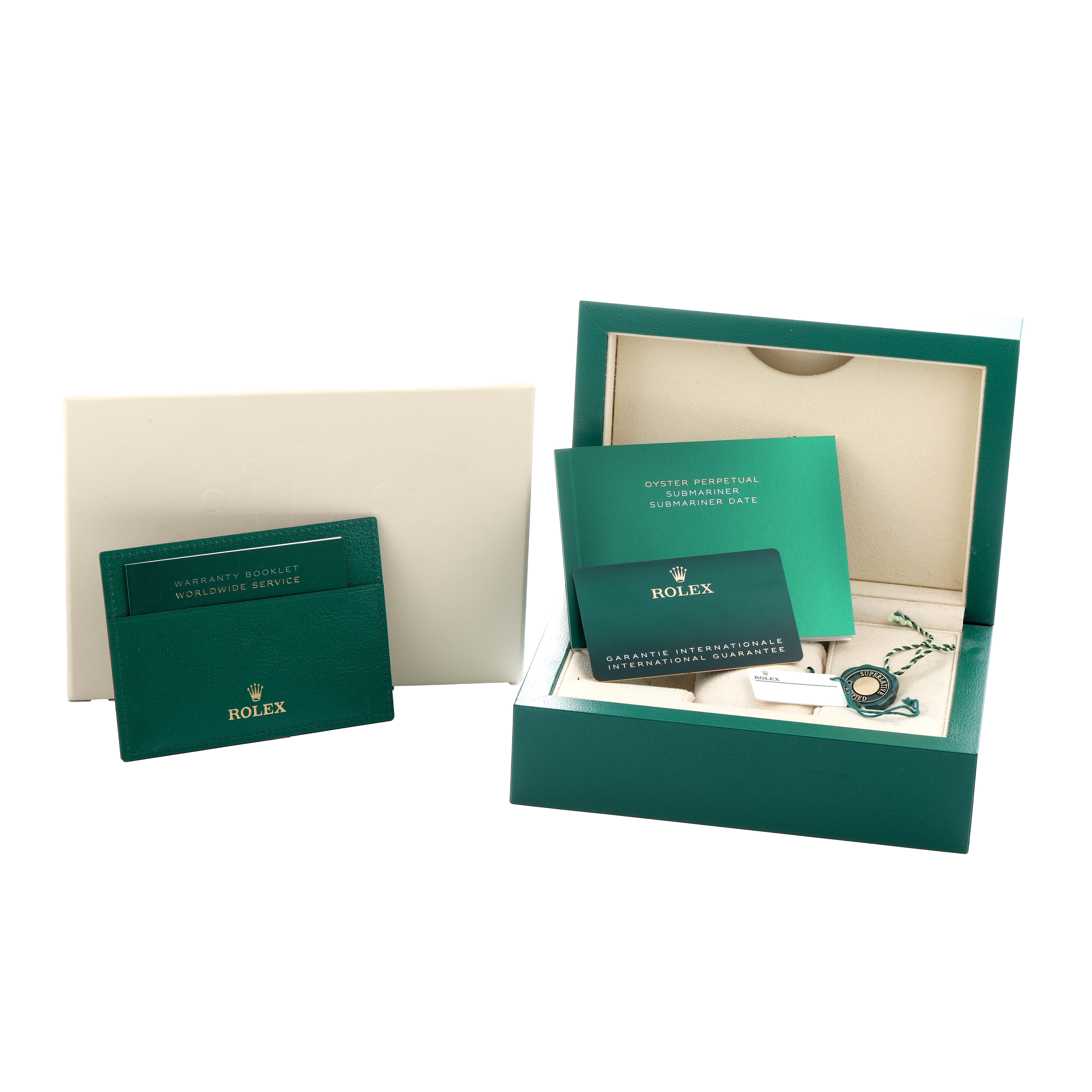 The image shows Rolex Submariner 126610 Men
s Stainless Steel Black Dial accessories, including a warranty booklet, international guarantee card, and a presentation box.
