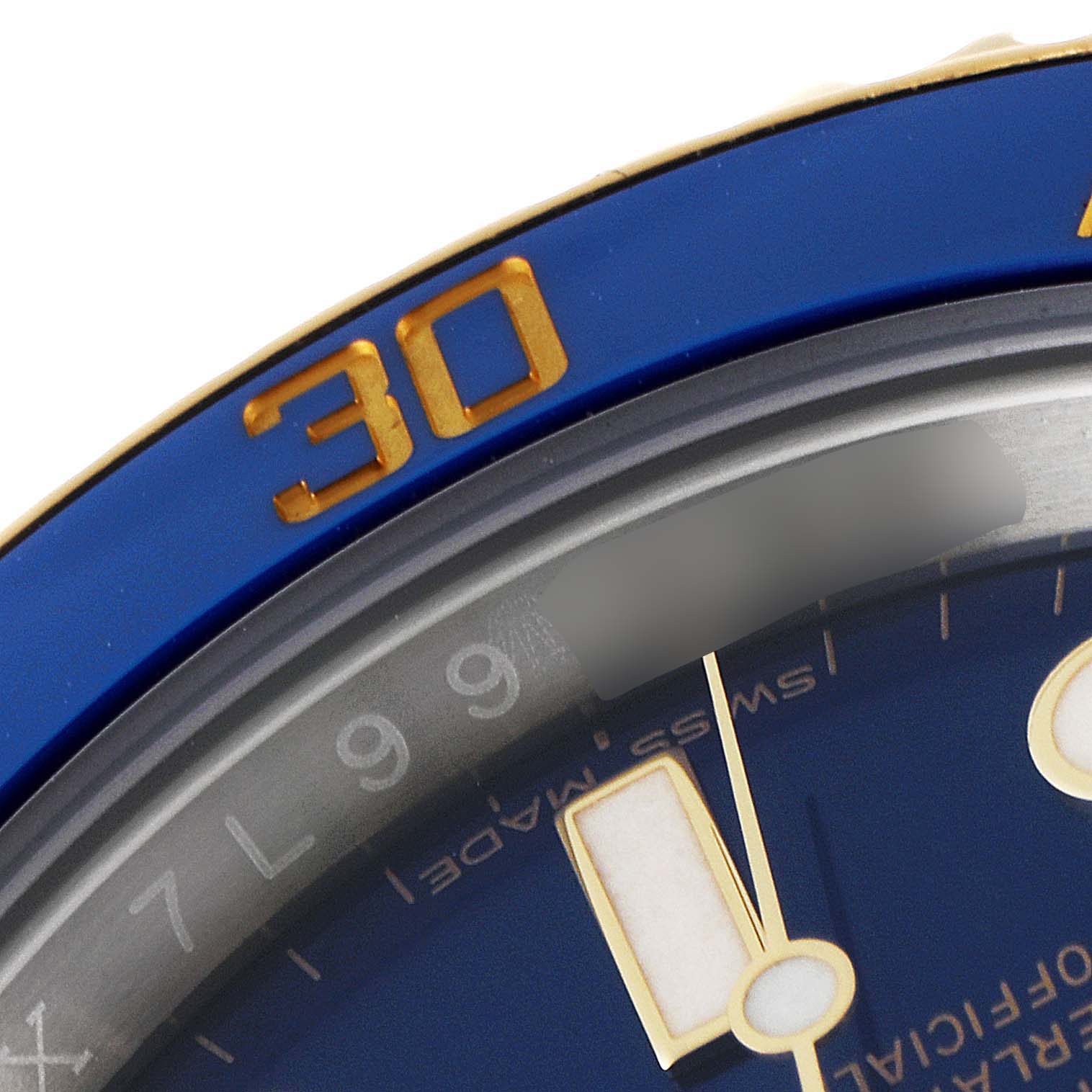 This close-up image of a Rolex Submariner 116613 Men's Steel and Gold (two tone) Blue Dial 116613 Men's Steel and Gold (two tone) Blue Dial watch shows part of the blue bezel, the number "30", and segments of the minute and hour hands.