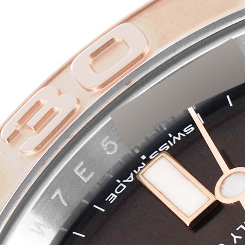 This close-up angle shows the bezel and part of the dial of the Rolex Yacht-Master 116621 Men's Steel and Gold (two tone) Brown Dial 116621 Men's Steel and Gold (two tone) Brown Dial model, including hour markers and part of the "Swiss Made" text.