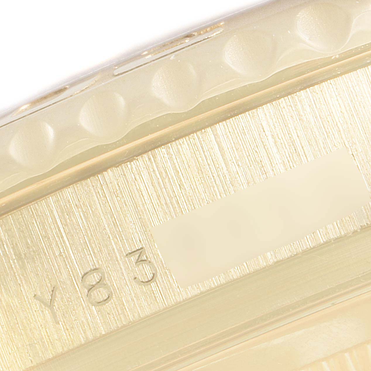 This close-up image shows the side of the Rolex Yacht-Master 16628 Men's Yellow Gold Blue Dial 16628 Men's Yellow Gold Blue Dial watch, focusing on the bezel and serial number.