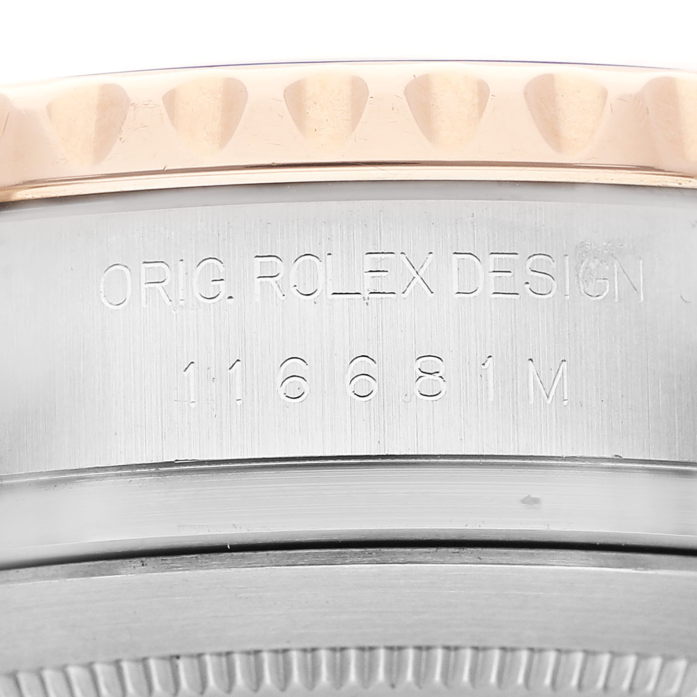 The image shows a close-up of the side of a Rolex Yacht-Master 116681 Men's Steel and Gold (two tone) White Dial, focusing on the engraved text on the case.