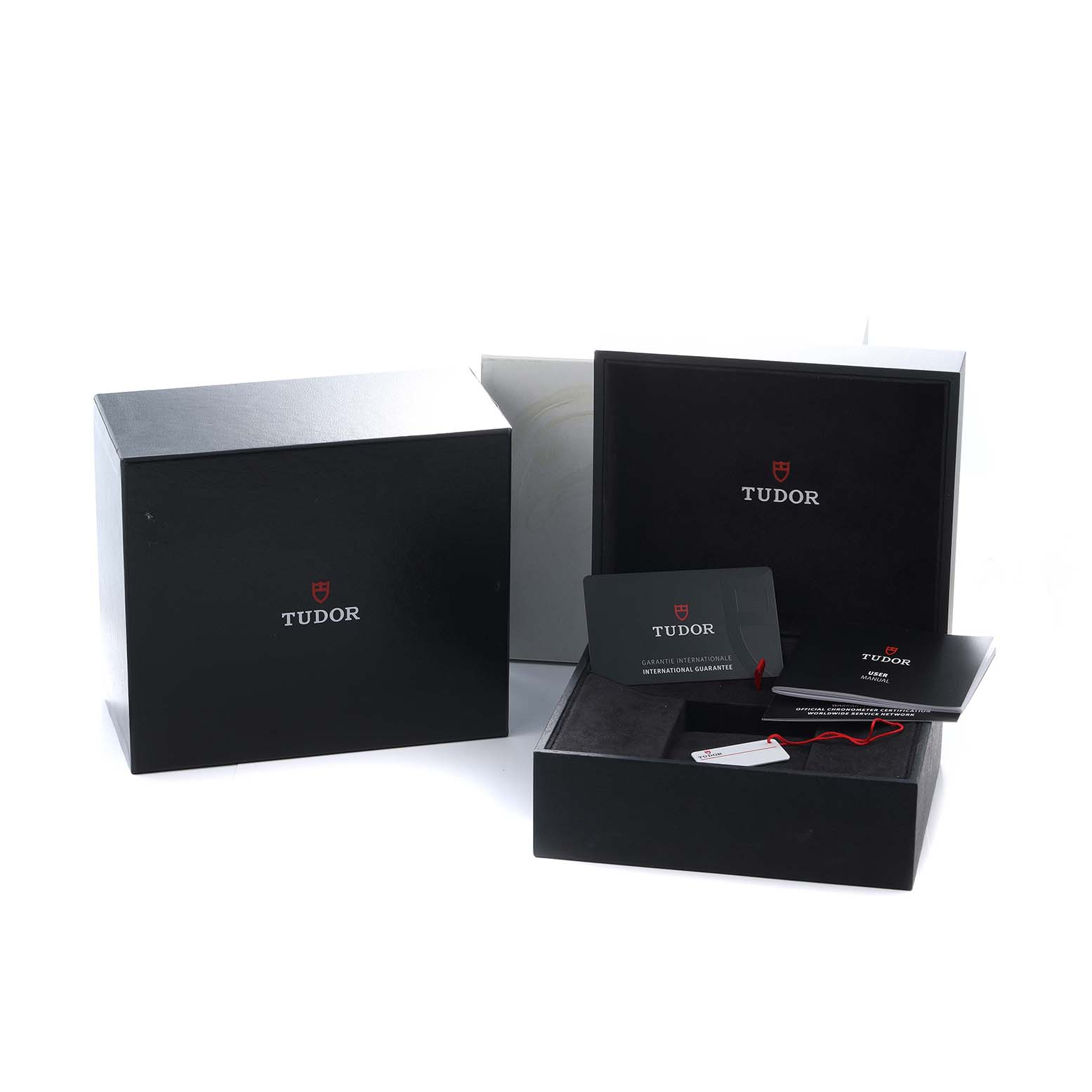 The image shows the Tudor Heritage Black Bay 79830RB Men
s Stainless Steel Black Dial packaging, including the box and guarantee card, viewed from a front angle.