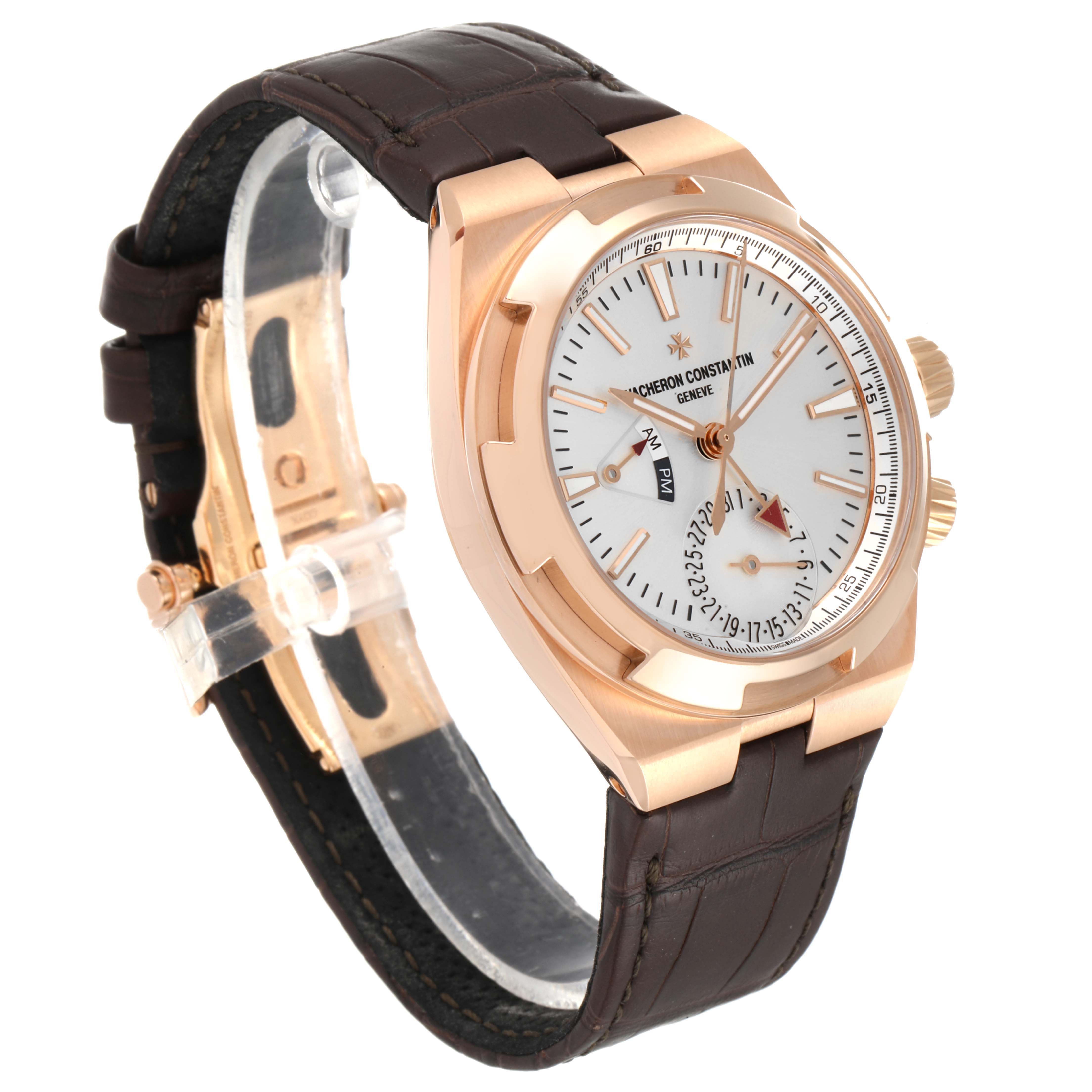 The image shows a side angle of the Vacheron Constantin Overseas 7900V/000R-B336 Men
s Rose Gold Silver Dial 7900V/000R-B336 Men
s Rose Gold Silver Dial watch featuring its gold case, white dial, and brown leather strap.