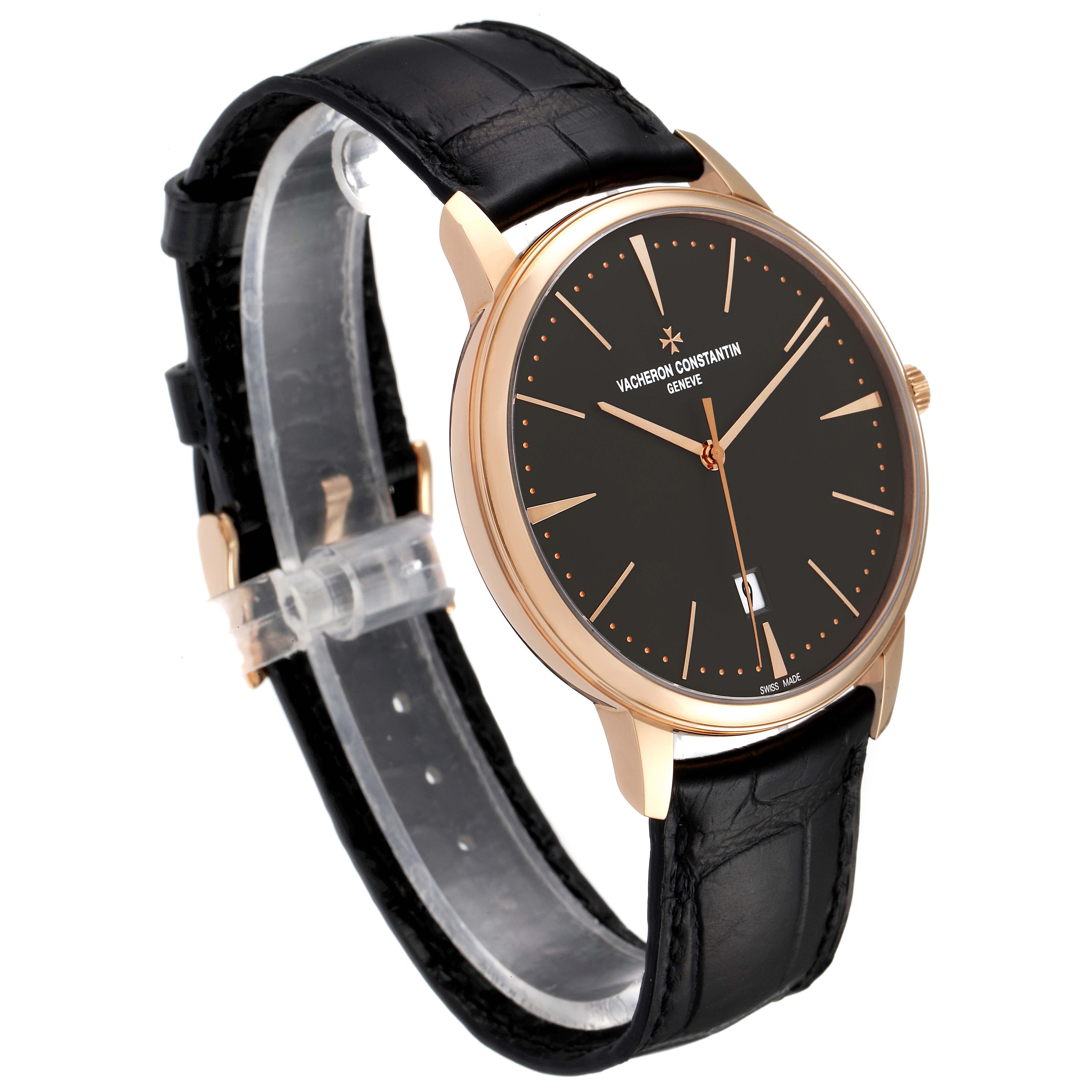 The image shows a Vacheron Constantin Patrimony 85180/000R-9166 Men's Rose Gold Grey Dial 85180/000R-9166 Men's Rose Gold Grey Dial watch at an angle highlighting its black dial, gold case, and black leather strap.