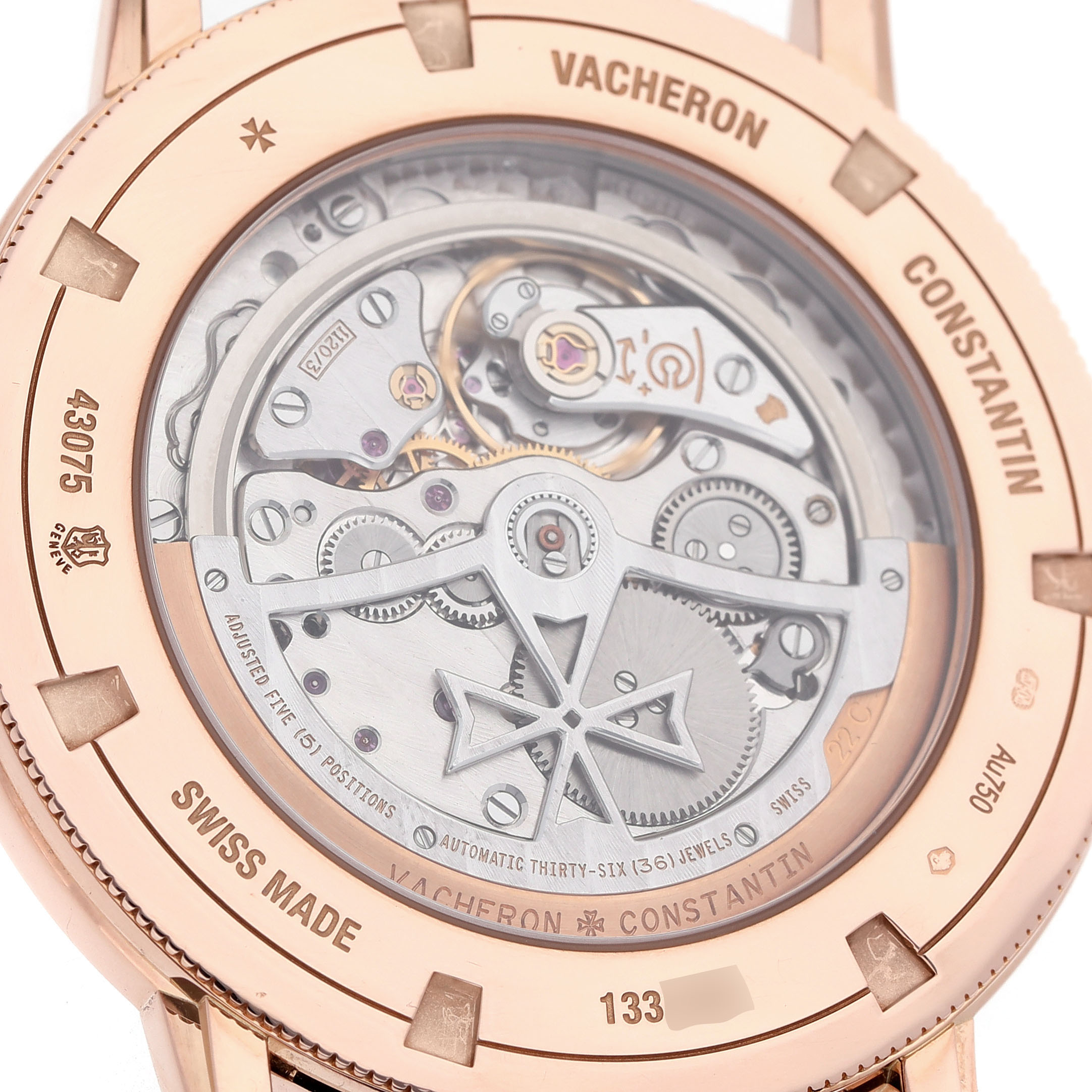 The image shows the back of a Vacheron Constantin Patrimony 43075/000R-9737 Men's Rose Gold Silver Dial watch, highlighting its intricate movement and mechanisms.
