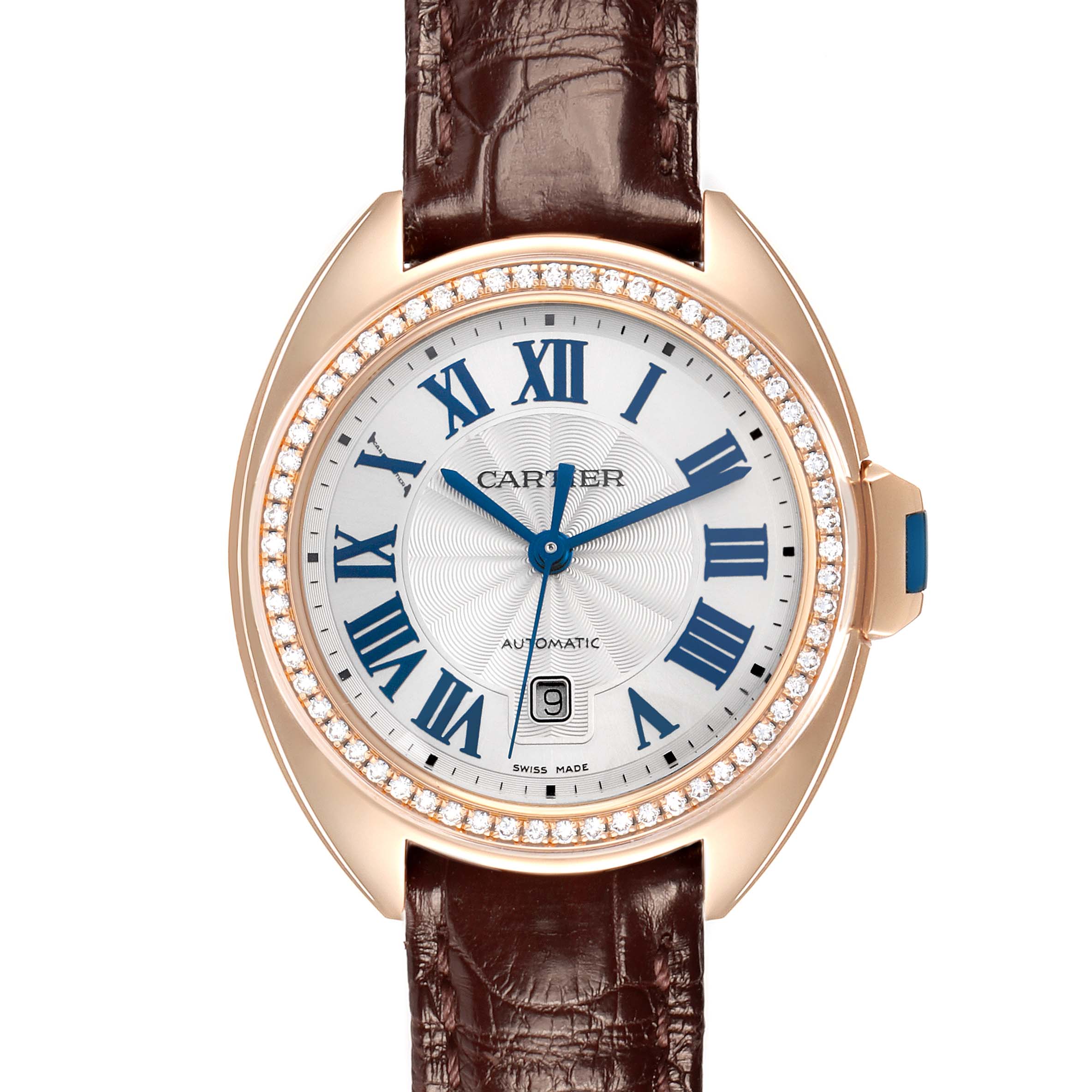 The Cartier Clé watch is shown from a top angle, displaying the dial, bezel, brown leather strap, and crown.