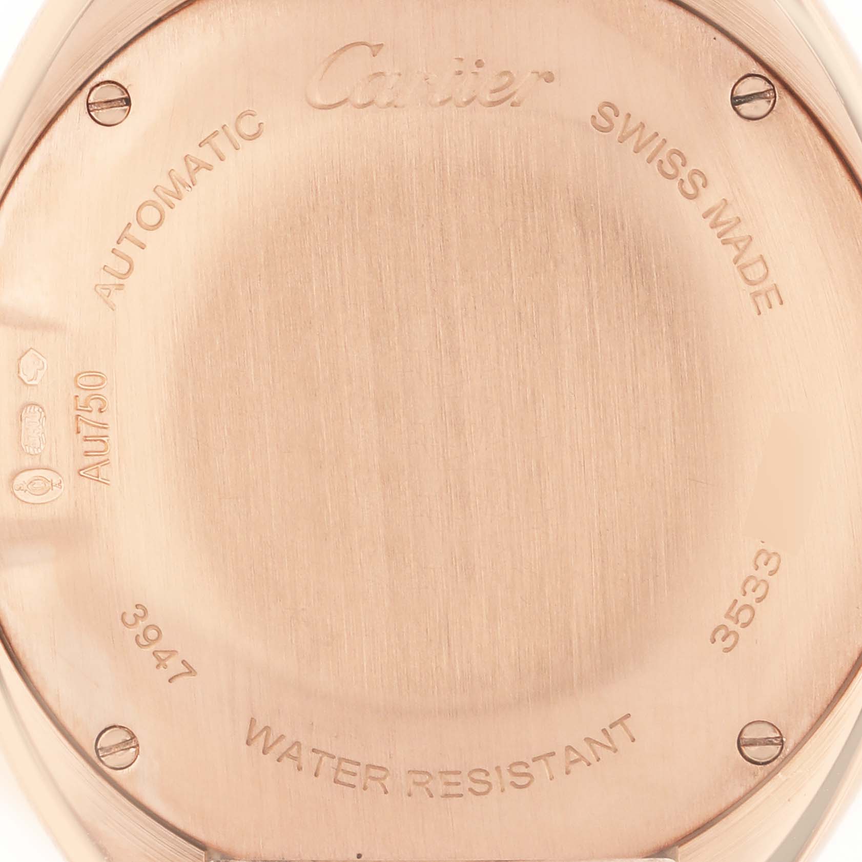 The image shows the back of a Cartier Clé watch, detailing engravings and screw placement.