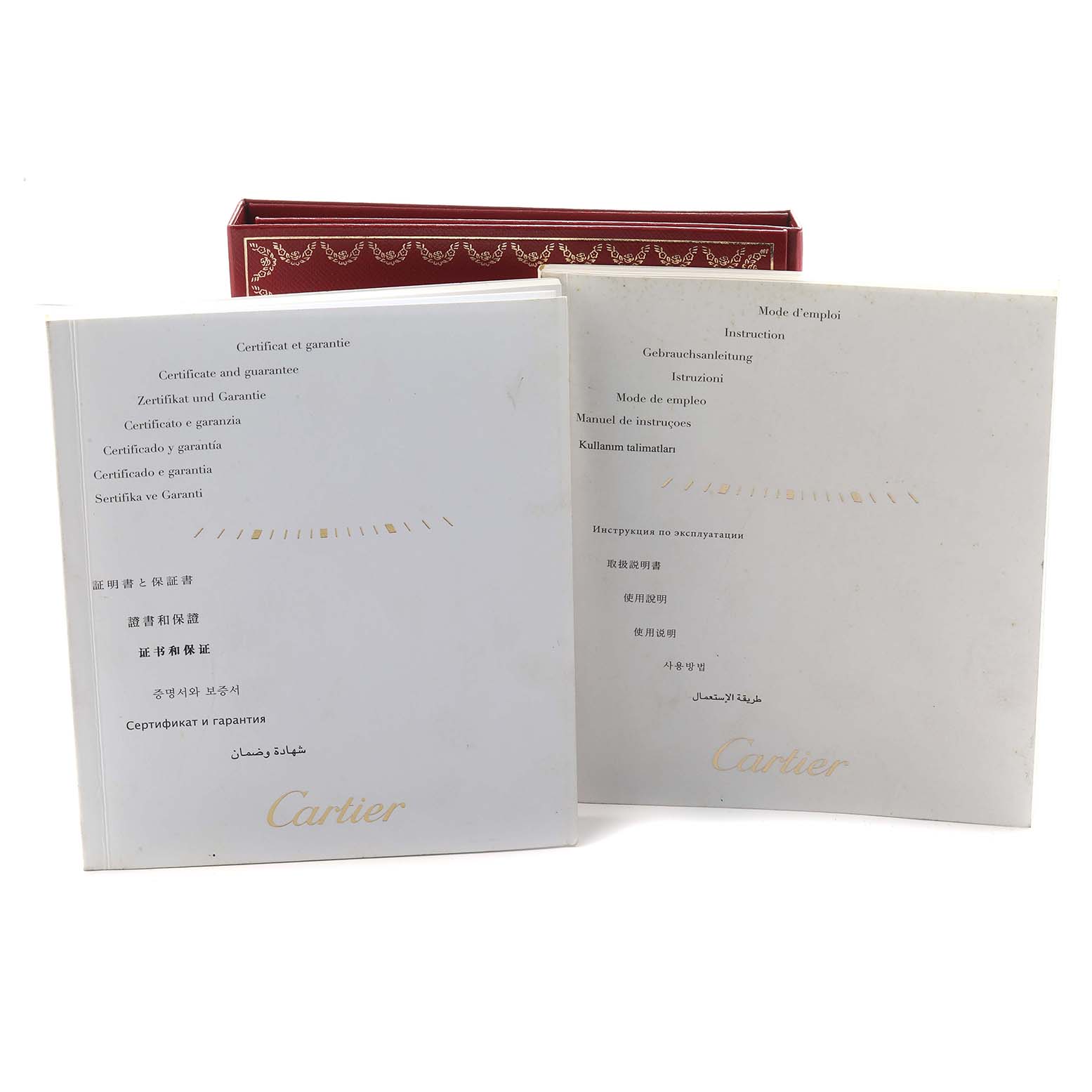 The image shows warranty and instruction booklets for the Cartier Ronde W6701009 Men
s Rose Gold Silver Dial watch, along with a red presentation box.