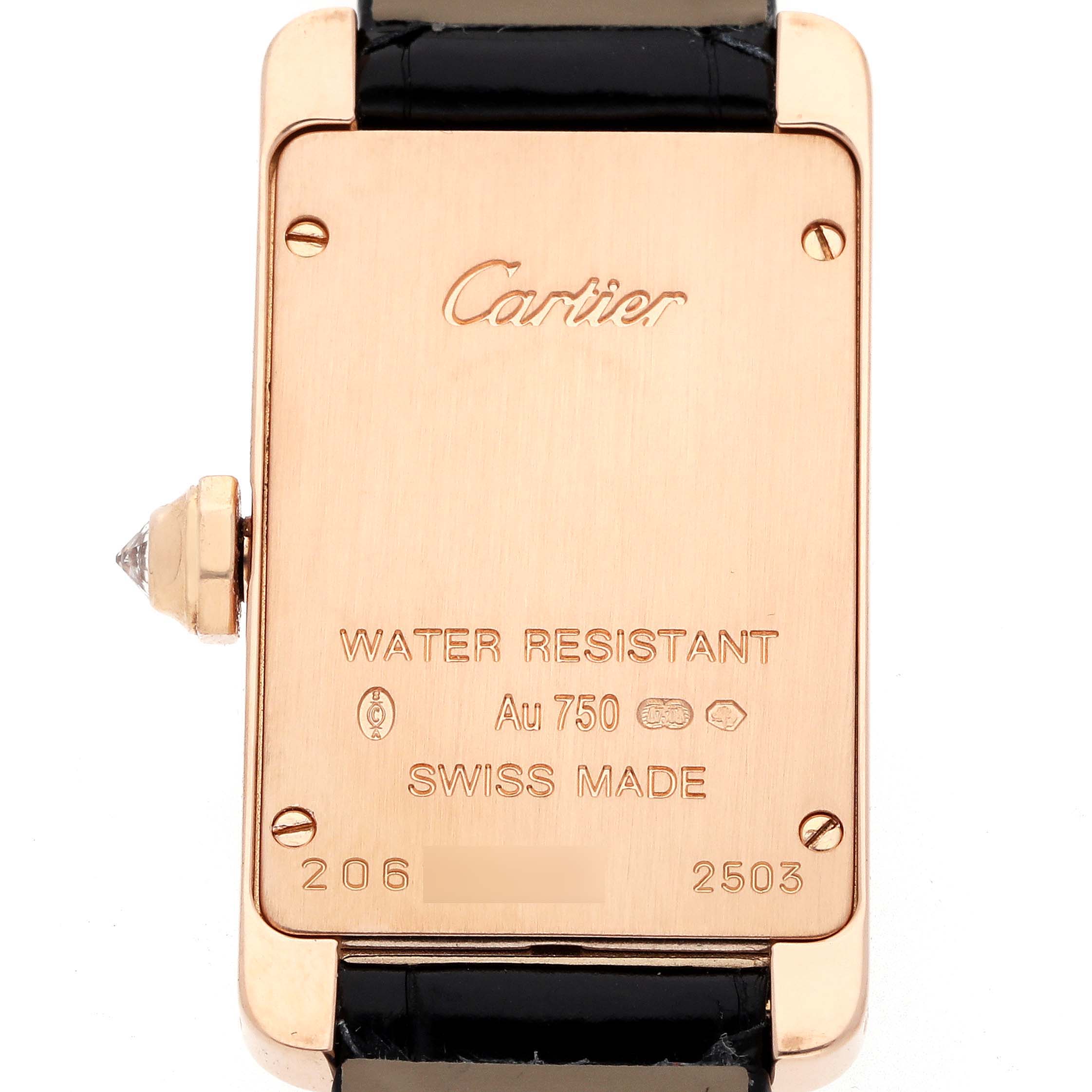 The image shows the back of a Cartier Tank Americaine WJTA0002 Women
s Rose Gold Silver Dial watch, highlighting its inscriptions and strap attachment.