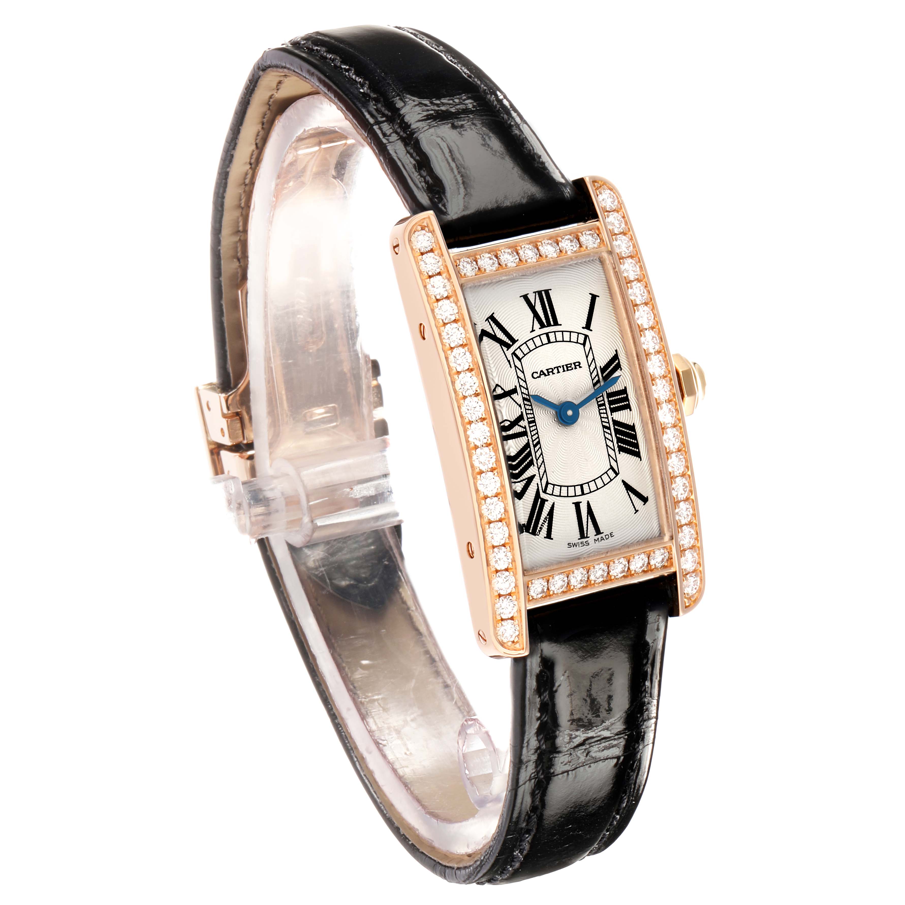 The Cartier Tank Américaine watch is angled to show its face, diamond-studded bezel, and black leather strap prominently.