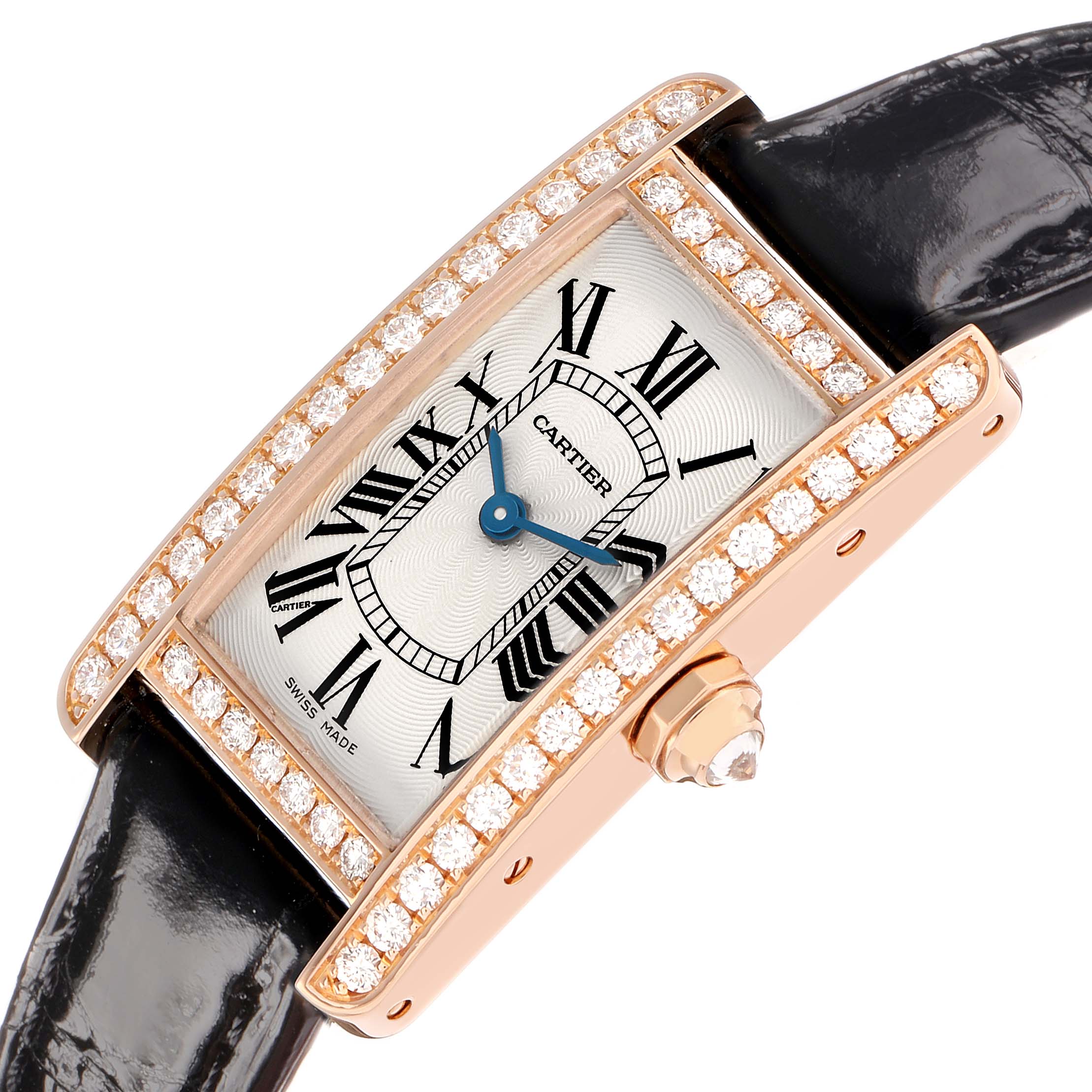 The Cartier Tank Americaine WJTA0002 Women
s Rose Gold Silver Dial watch is shown at an angled view, highlighting its diamond-studded rectangular case, dial, and crown.