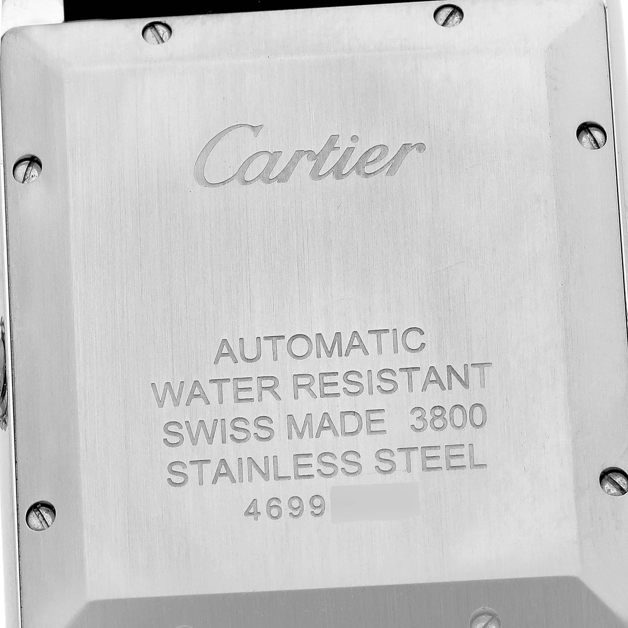 The image shows the back of the Cartier Tank Solo WSTA0029 Men's Stainless Steel Silver Dial WSTA0029 Men's Stainless Steel Silver Dial watch, highlighting its engravings and screws.