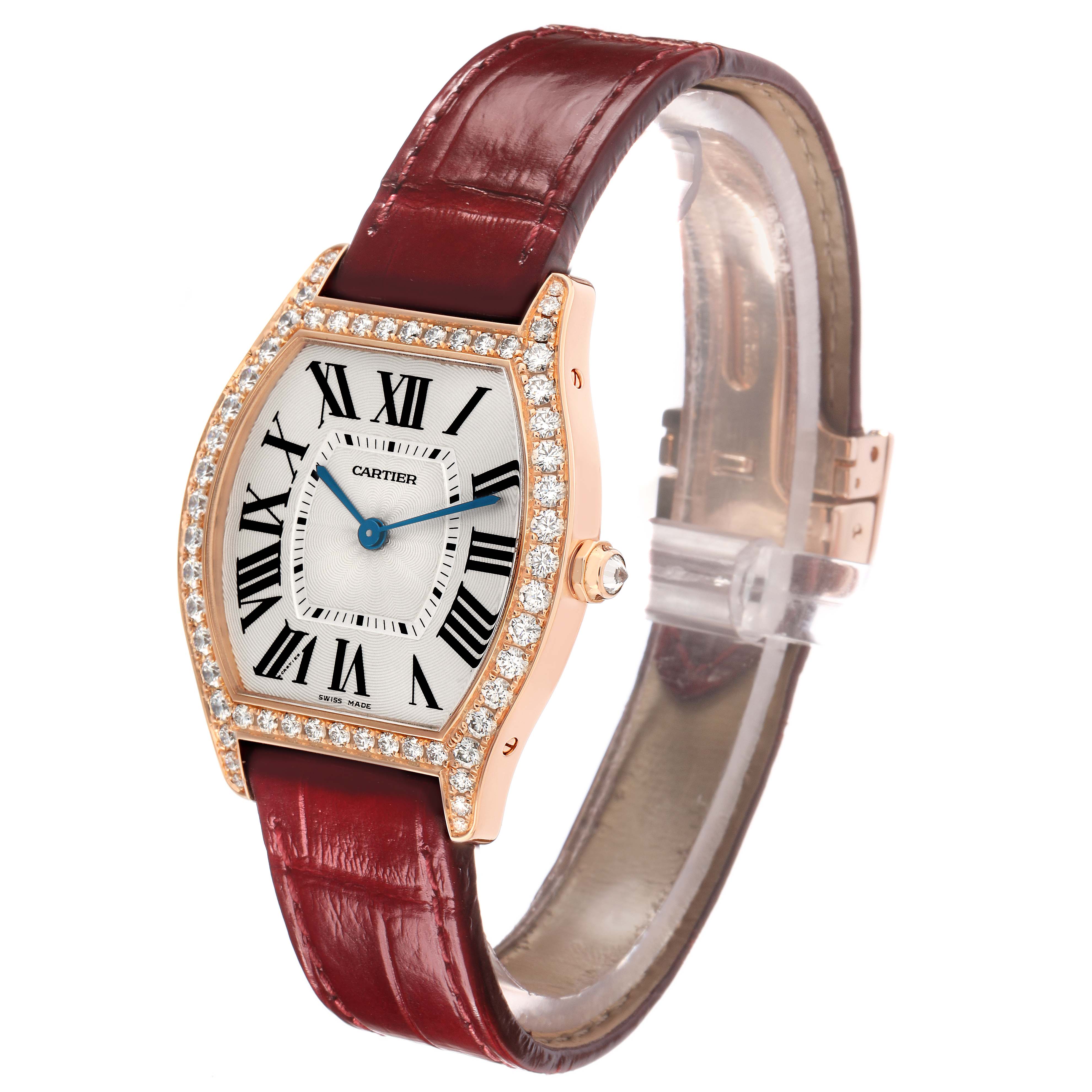 The Cartier Tortue WA501008 Women's Rose Gold Silver Dial watch is shown at a three-quarter angle, highlighting its diamond-set bezel, dial, and burgundy strap.