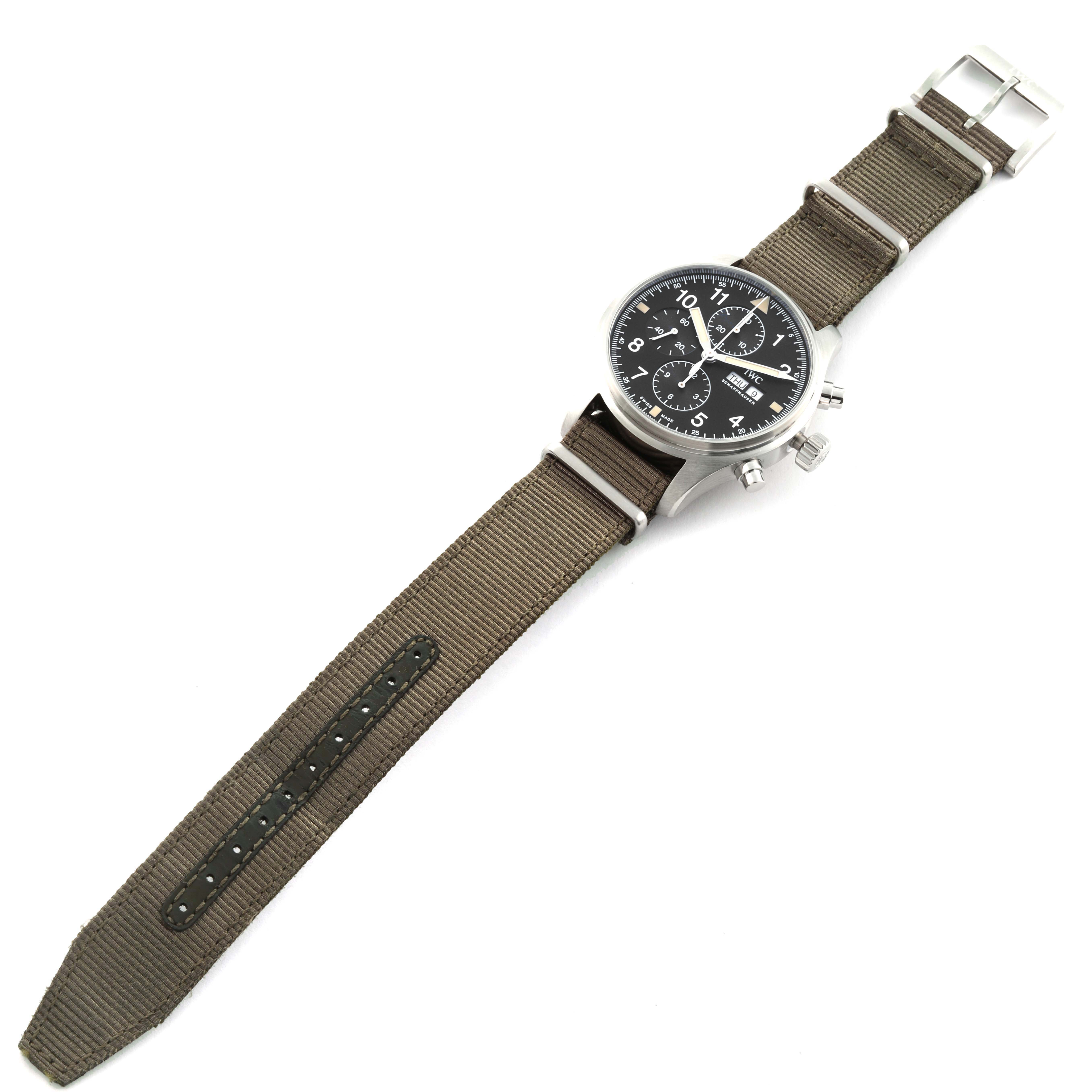 The IWC Pilot IW377724 Men's Stainless Steel Black Dial IW377724 Men's Stainless Steel Black Dial watch is shown at an overhead angle, displaying the entire watch including the black dial and brown strap.