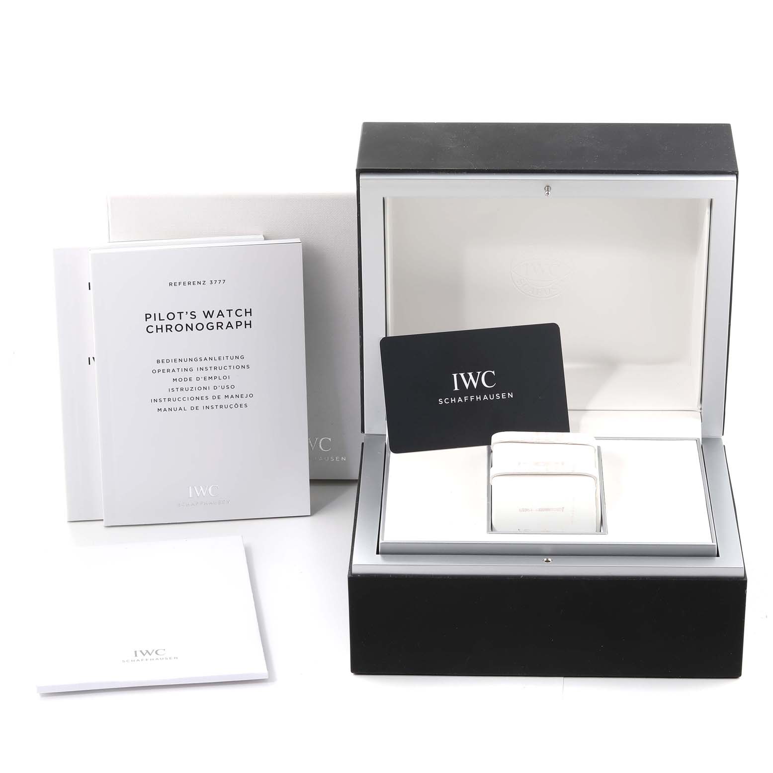 The image shows an IWC Pilot IW377724 Men's Stainless Steel Black Dial IW377724 Men's Stainless Steel Black Dial model watch box, booklet, and warranty card from a top-down angle.