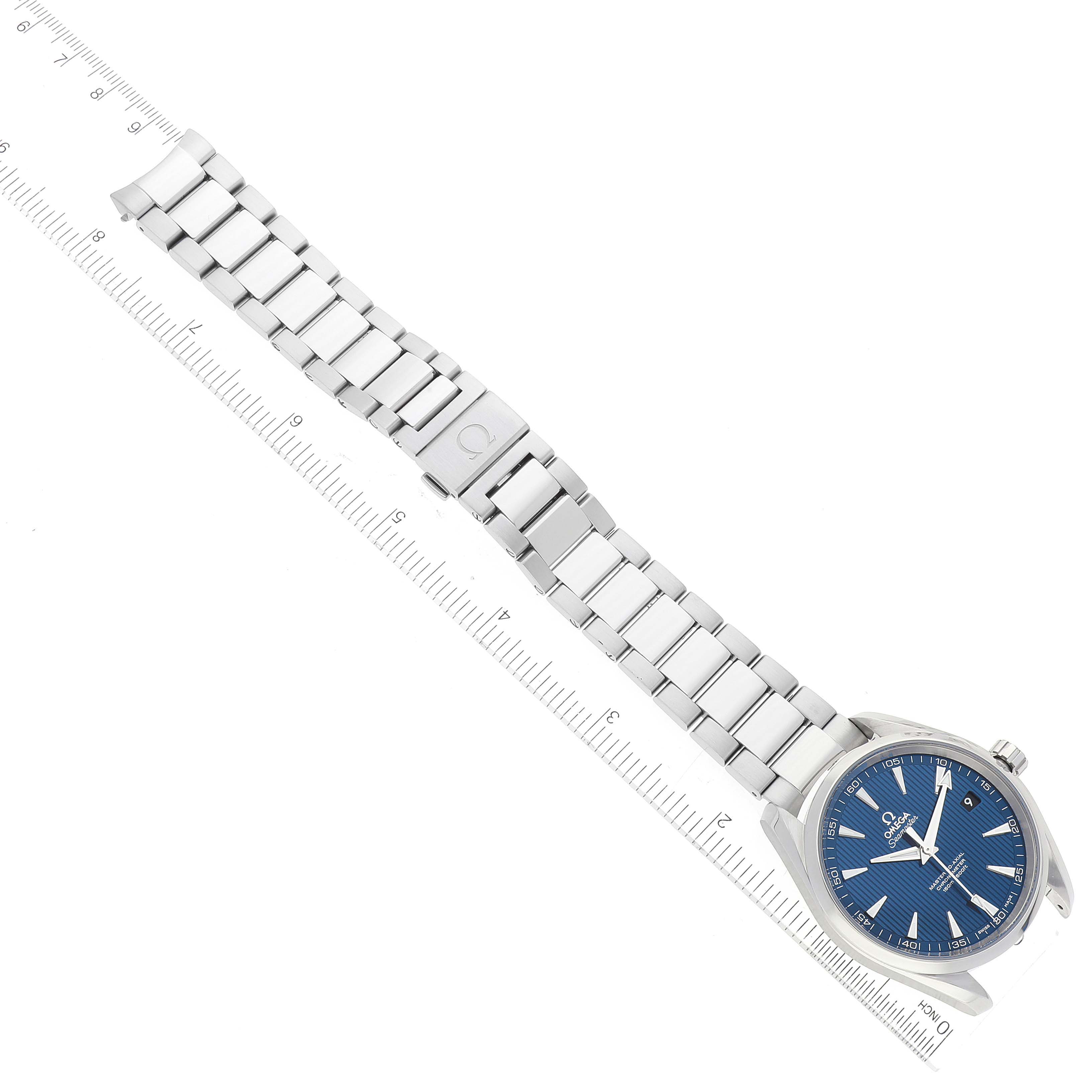 The Omega Aqua Terra 231.10.42.21.03.001 Men
s Stainless Steel Blue Dial 231.10.42.21.03.001 Men
s Stainless Steel Blue Dial watch is shown at an overhead angle, displaying the blue dial, stainless steel bracelet, and clasp alongside a ruler.