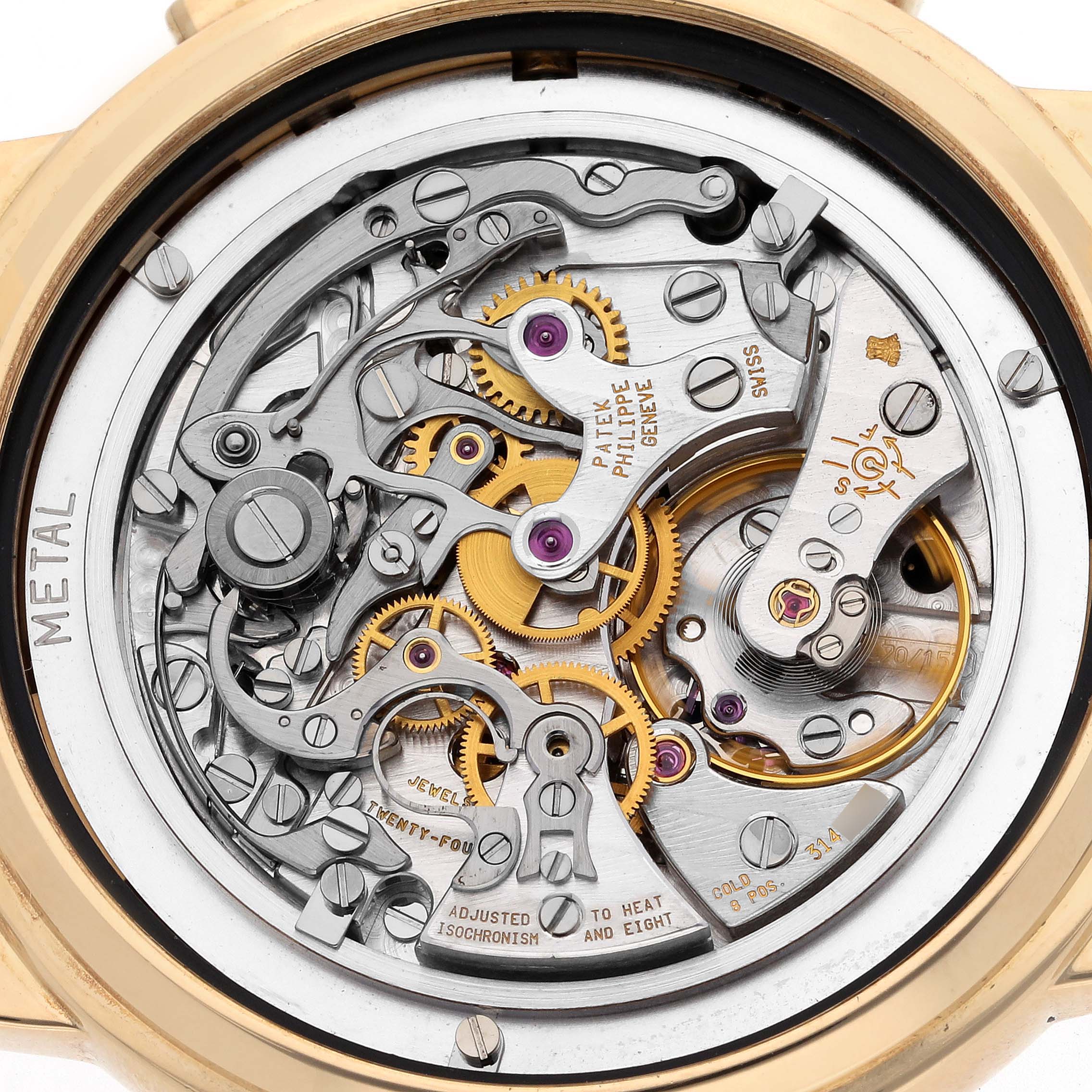 The image shows the intricate back movement of a Patek Philippe Complications 5070J-001 Men's Yellow Gold Black Dial 5070J-001 Men's Yellow Gold Black Dial watch, highlighting gears and mechanisms.