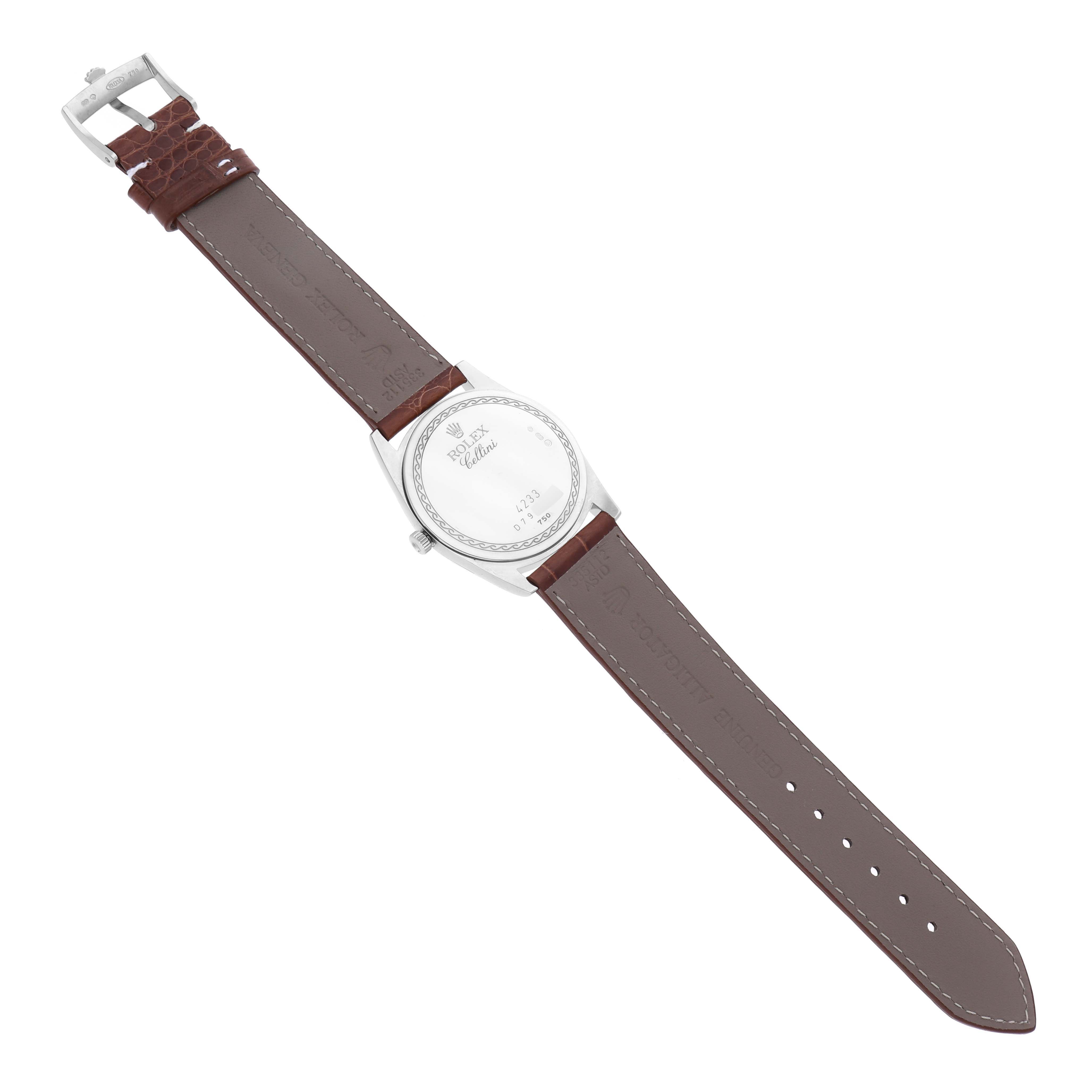 The Rolex Cellini 4233/9 Men's Steel and Gold (two tone) White Dial 4233/9 Men's Steel and Gold (two tone) White Dial watch is shown from the back, displaying its case back and brown leather strap with a buckle.