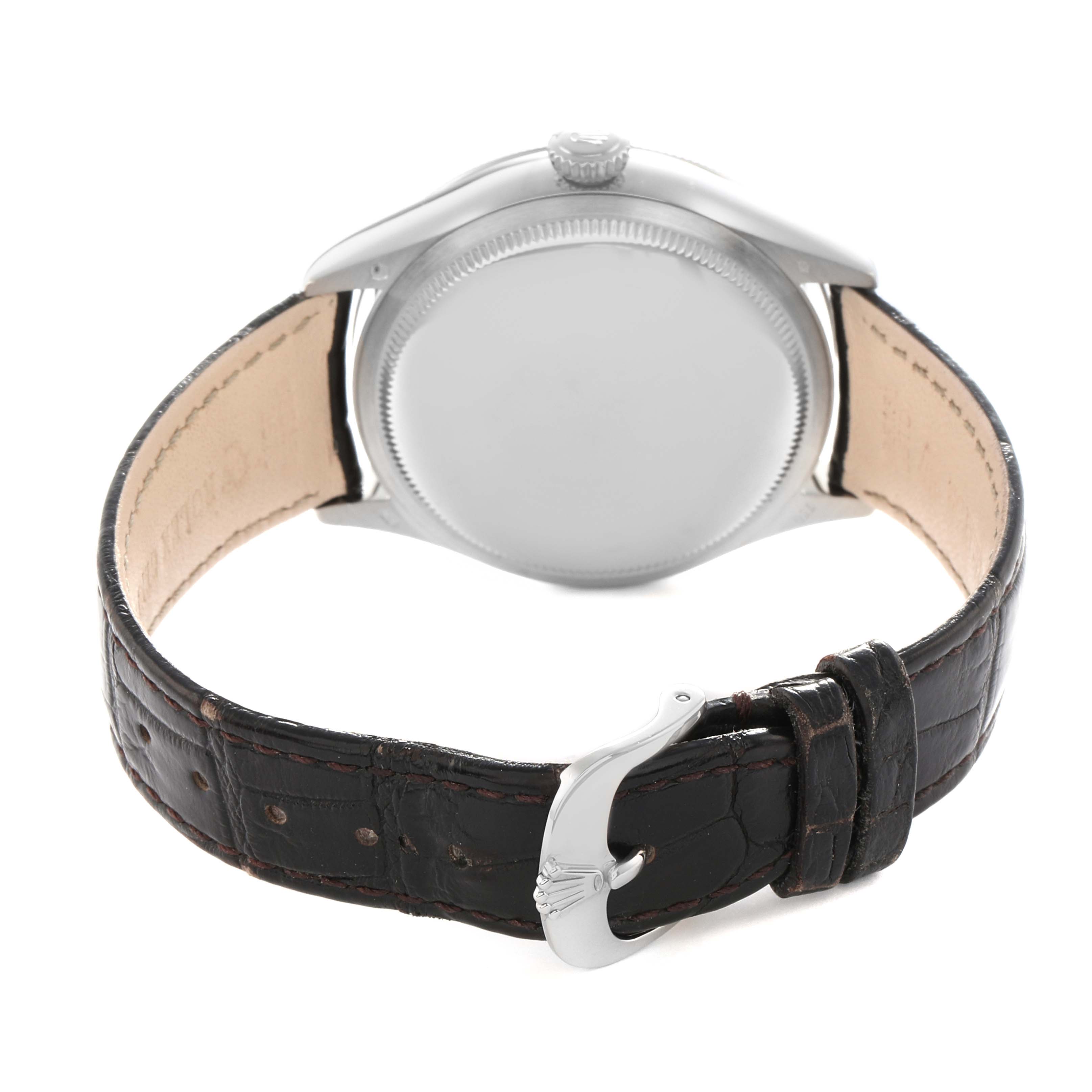 The image shows the back view of a Rolex Cellini 50519 Men
s White Gold Silver Dial, highlighting the case back, leather strap, and clasp.