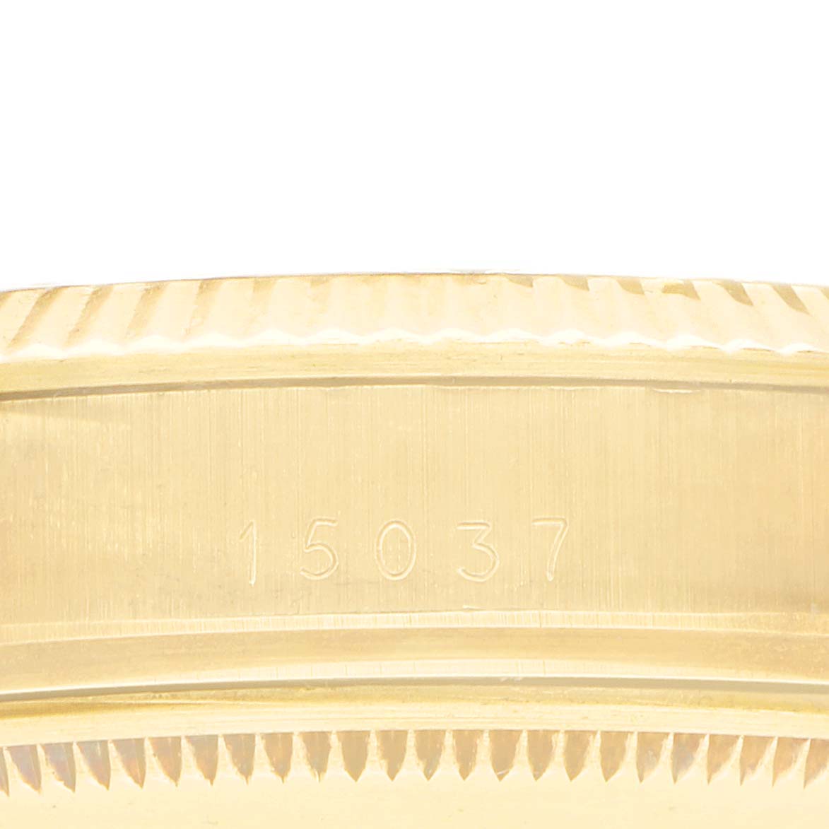 The image shows a close-up of the side of a Rolex Date 15037 Men
s Yellow Gold Champagne Dial model watch case, focusing on the engraved model number.