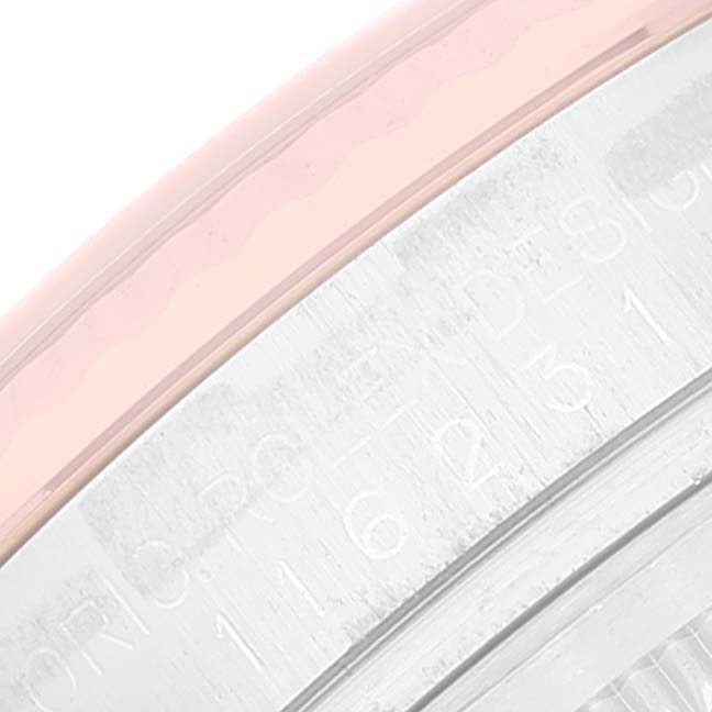 This close-up image shows a portion of the bezel and case of a Rolex Datejust 116231 Men's Steel and Gold (two tone) White Dial 116231 Men's Steel and Gold (two tone) White Dial watch.