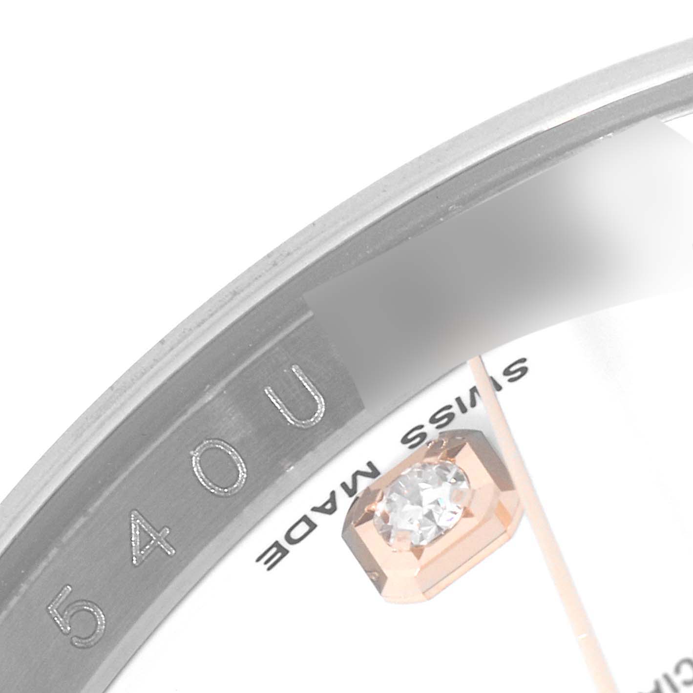 The image shows a close-up of the bezel and dial of a Rolex Datejust 116231 Men's Steel and Gold (two tone) White Dial 116231 Men's Steel and Gold (two tone) White Dial watch, highlighting the serial number and a diamond hour marker.