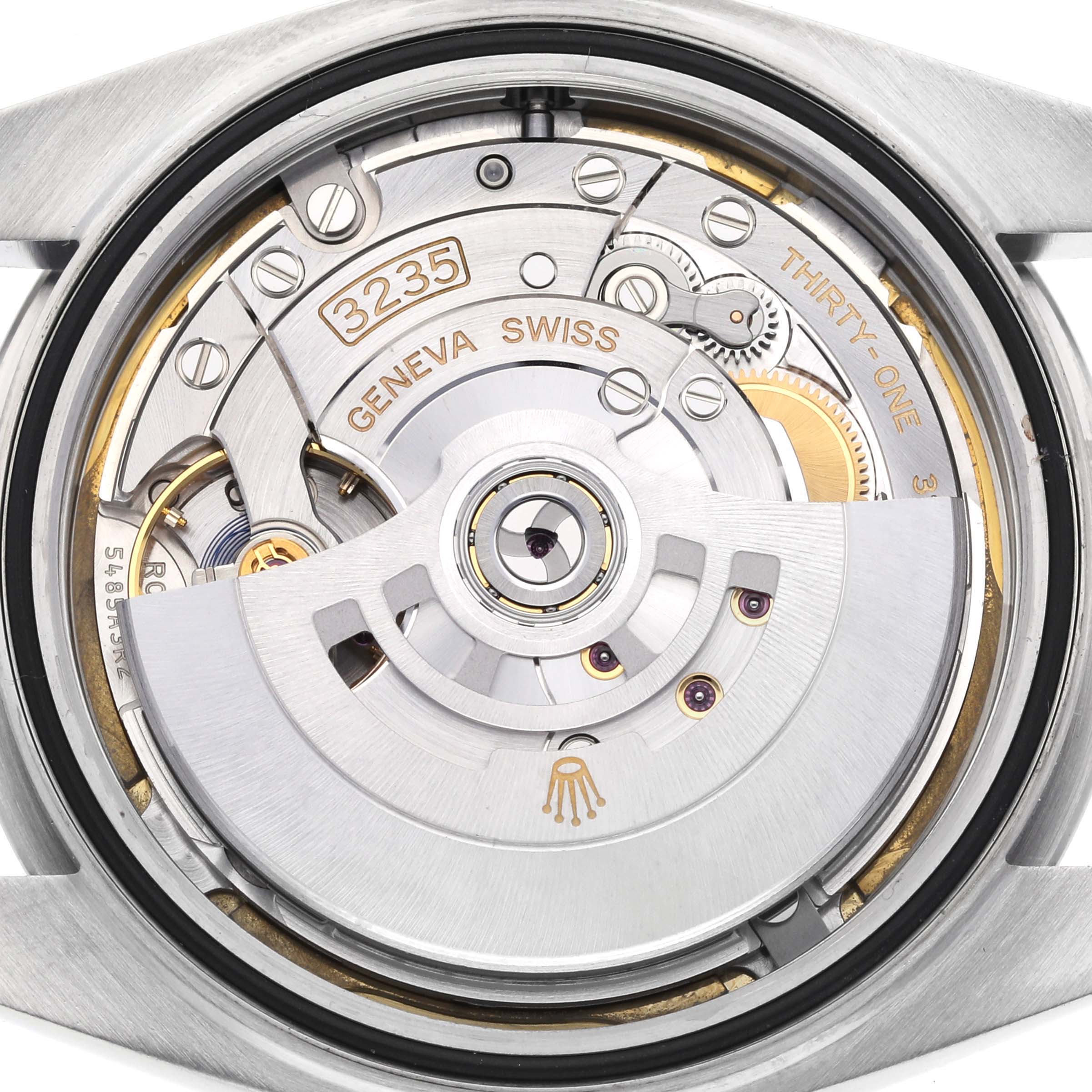 The image shows the movement of a Rolex Datejust 41 126300 Men's Stainless Steel White Dial 126300 Men's Stainless Steel White Dial watch from a rear angle, highlighting its intricate mechanics.