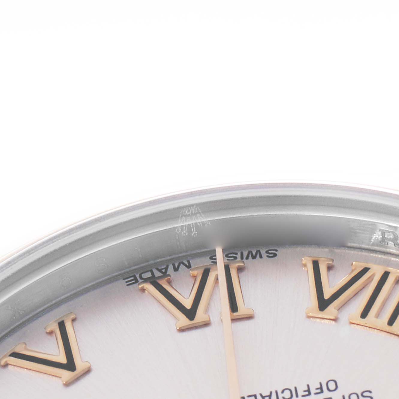 The image shows a close-up of a Rolex Mid-Size 178241 Women
s Steel and Gold (two tone) Pink Dial model
s dial, highlighting Roman numerals and part of the bezel.