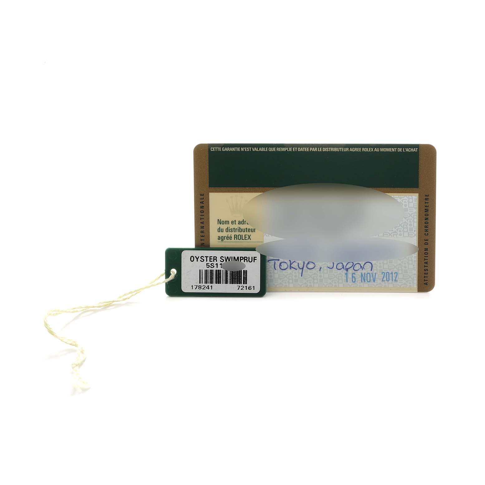 The image shows a Rolex warranty card and a green tag labeled "Oyster Swimpruf" for a Mid-Size model, viewed from the front.