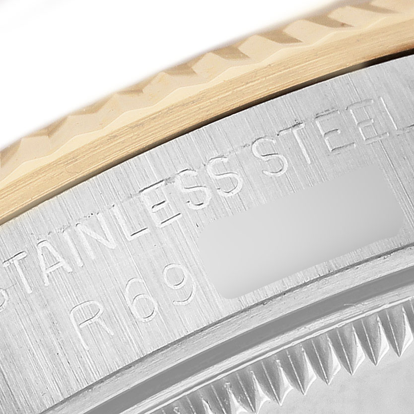 The image shows the side angle of a Rolex Mid-Size 68273 Women's Steel and Gold (two tone) Champagne Dial watch, focusing on the stainless steel case with visible engraving.
