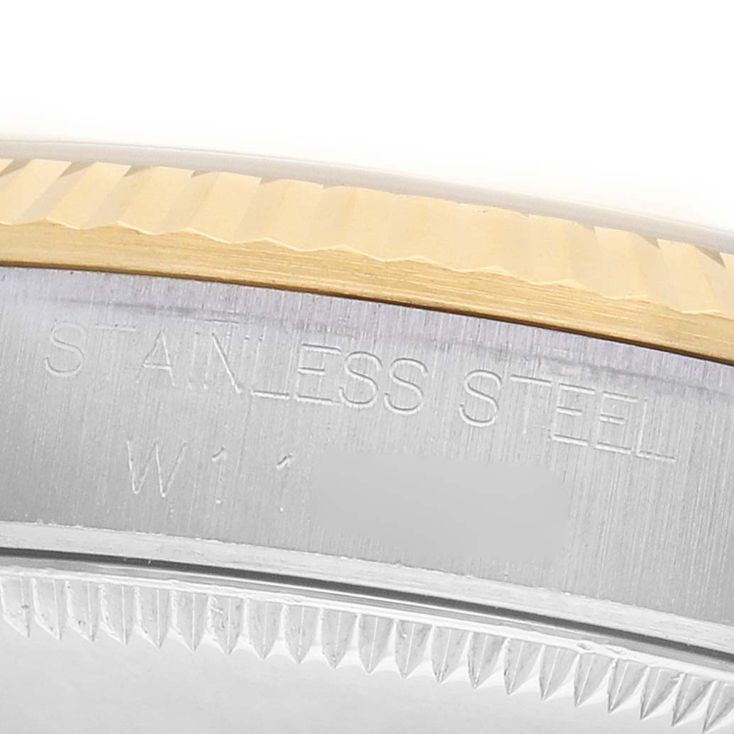 The image shows a close-up of the Rolex Mid-Size 68273 Women's Steel and Gold (two tone) Champagne Dial watch bezel, highlighting the stainless steel and gold detailing.