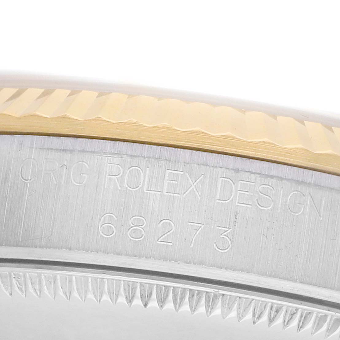 The image shows a close-up of the side of a Rolex Mid-Size 68273 Women's Steel and Gold (two tone) Champagne Dial watch, highlighting its bezel and engraved case design details.