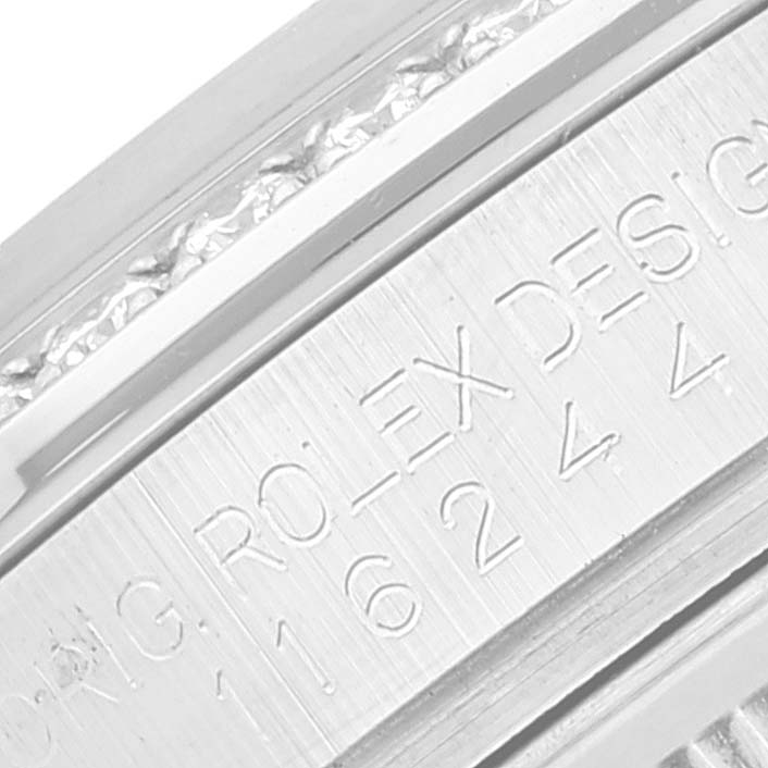 The image shows an angled close-up of the engraved serial number and "ROLEX DESIG" on the inner bezel of a Rolex Datejust 116244 Men's Stainless Steel Mother of Pearl Dial 116244 Men's Stainless Steel Mother of Pearl Dial model.