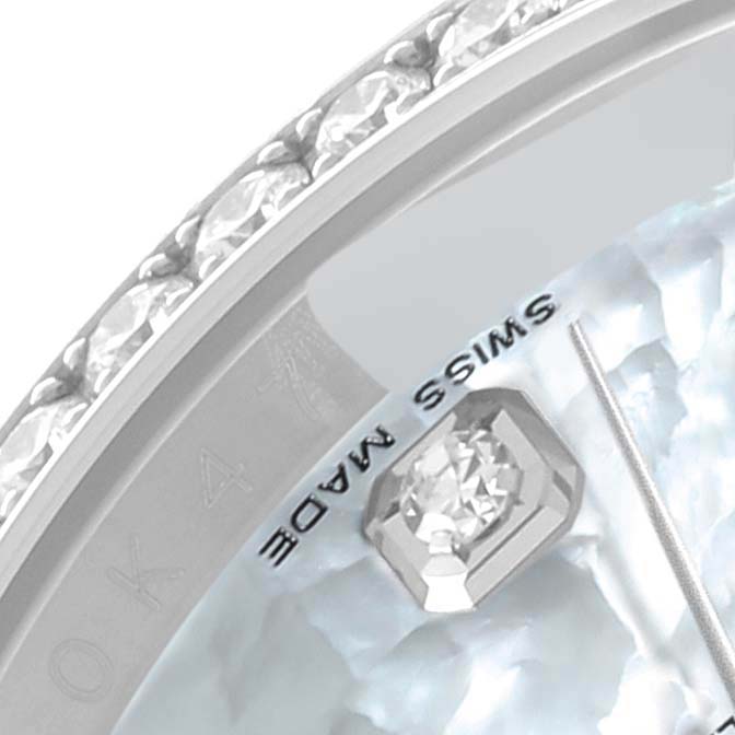 This close-up image of a Rolex Datejust 116244 Men's Stainless Steel Mother of Pearl Dial 116244 Men's Stainless Steel Mother of Pearl Dial watch shows a portion of the diamond-encrusted bezel and part of the dial with a diamond marker.
