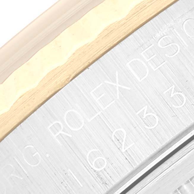 The image shows a close-up view of the engraved bezel of a Rolex Datejust 16233 Men's Stainless Steel Champagne Dial 16233 Men's Stainless Steel Champagne Dial watch.