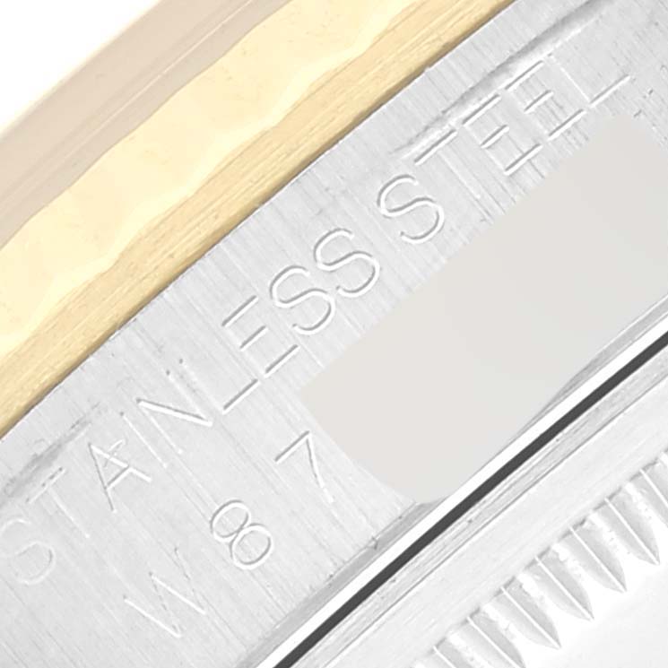 This close-up image shows the side of the case and part of the bezel of a Rolex Datejust 16233 Men's Stainless Steel Champagne Dial 16233 Men's Stainless Steel Champagne Dial watch, highlighting the stainless steel marking.