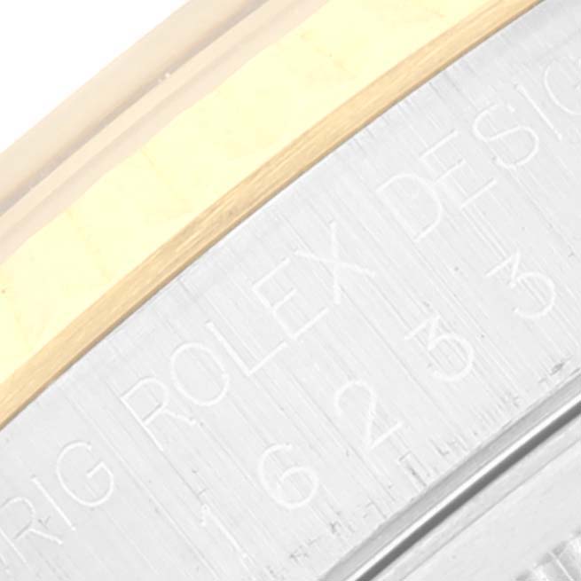 The image shows a close-up of the side edge of the caseback of a Rolex Datejust 16233 Men's Stainless Steel Blue Dial 16233 Men's Stainless Steel Blue Dial watch, featuring engraved text.