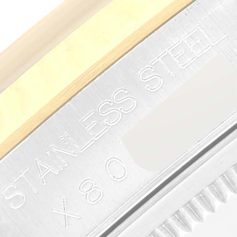 This close-up image shows the side engraving and part of the bezel of a Rolex Datejust 16233 Men's Stainless Steel Blue Dial 16233 Men's Stainless Steel Blue Dial watch.